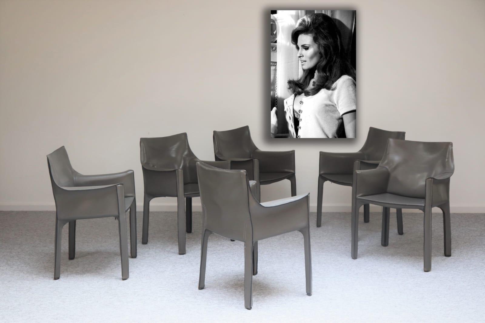 Six Mario Bellini Cab 413 armchairs, fabricated by Cassina in the 1990s. Flexible steel frame covered with a skin of high quality black saddle leather. This elegant, versatile chair is equally suitable for the dining room, study or living room.