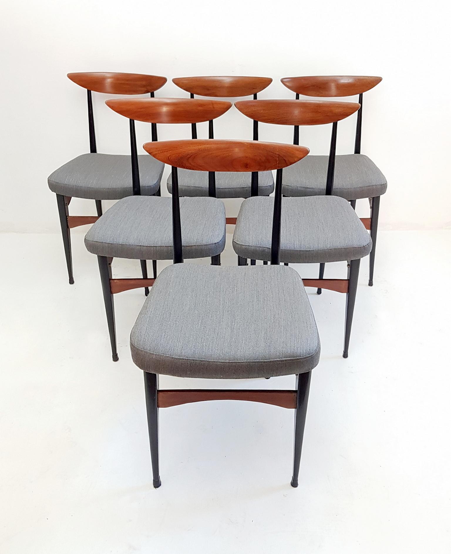 A set of six Italian dining chairs with a strict design in teak and blackened wood and reupholstered in gray Italian soft wool. The chairs are lightweight but very stabile and robust. The chairs have supreme craftsmanship and have recently been
