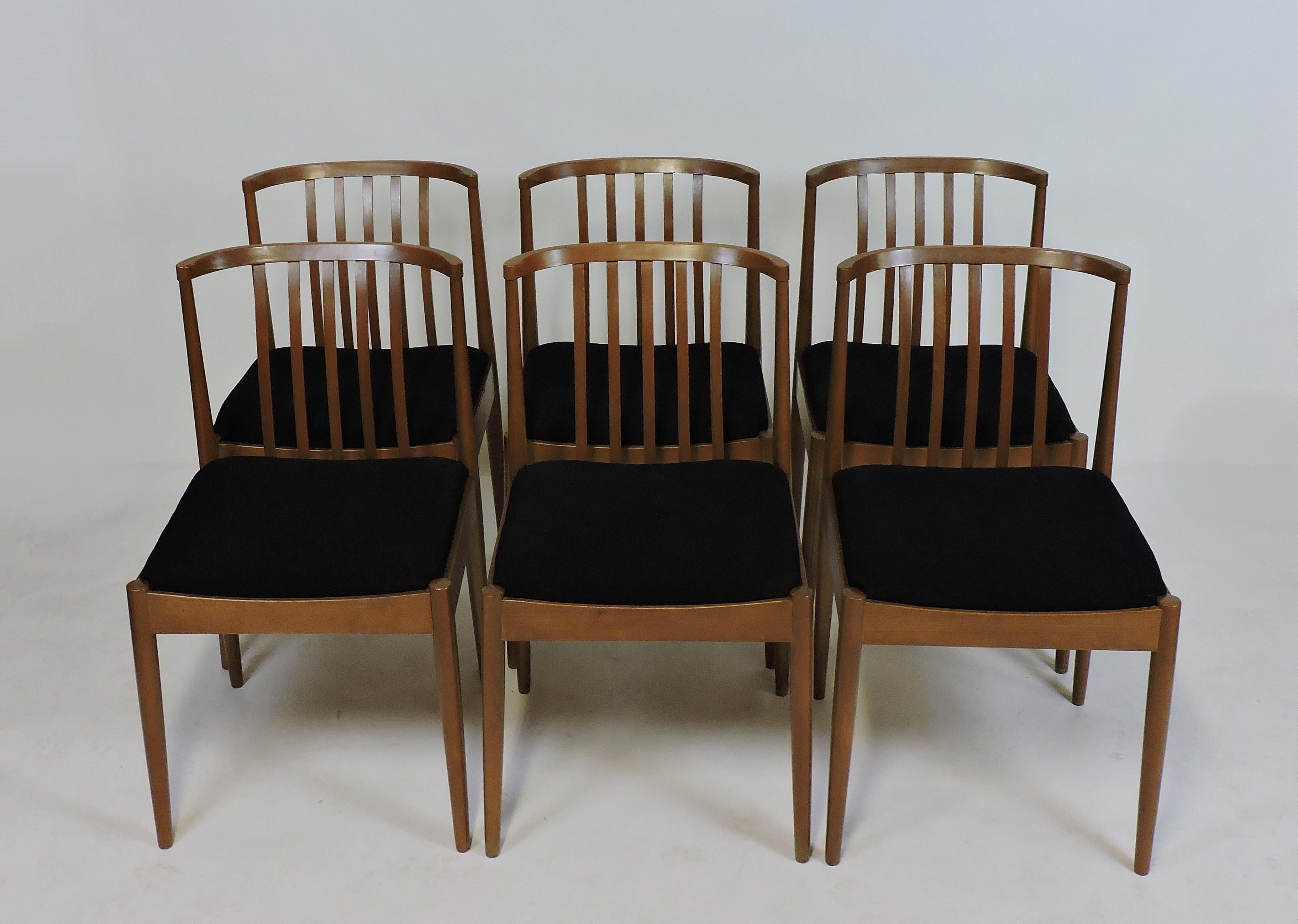 Set of six elegant and well made midcentury dining chairs manufactured in Germany by Casala Modell. These chairs have slatted backs, tapered legs, and upholstered seats which have been newly reupholstered in black fabric.
The last picture shows the