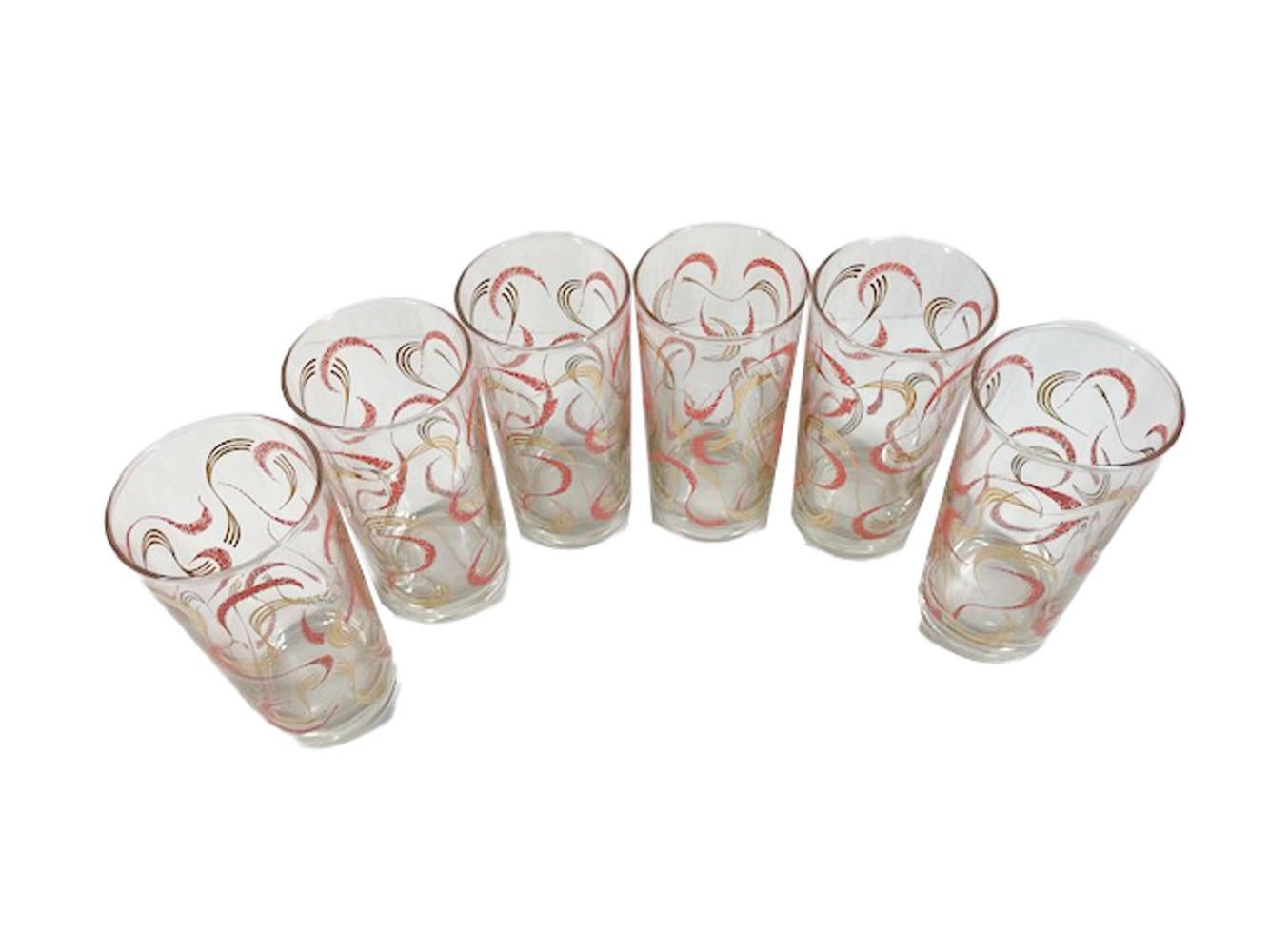 Six Mid-Century Modern highball glasses in the atomic style decorated with 22k gold and pink enamel streamers.