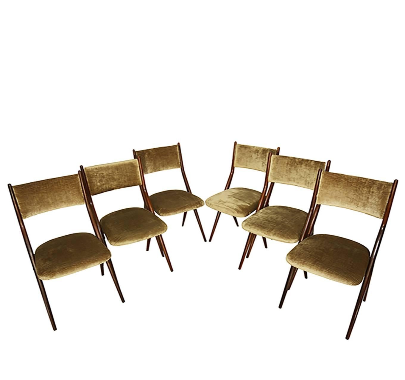 Chic sculptural scissor shape dining chairs. Mahogany frames with taupe color velvet upholstery. They are in excellent condition.