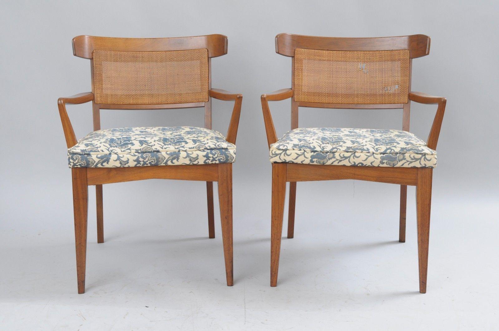 Set of six Mid-Century Modern walnut curved cane back dining chairs by Modern Manor Inc. Item features two armchairs, four side chairs, solid walnut wood construction, curved and caned backs, tapered legs, original label to underside. Style similar