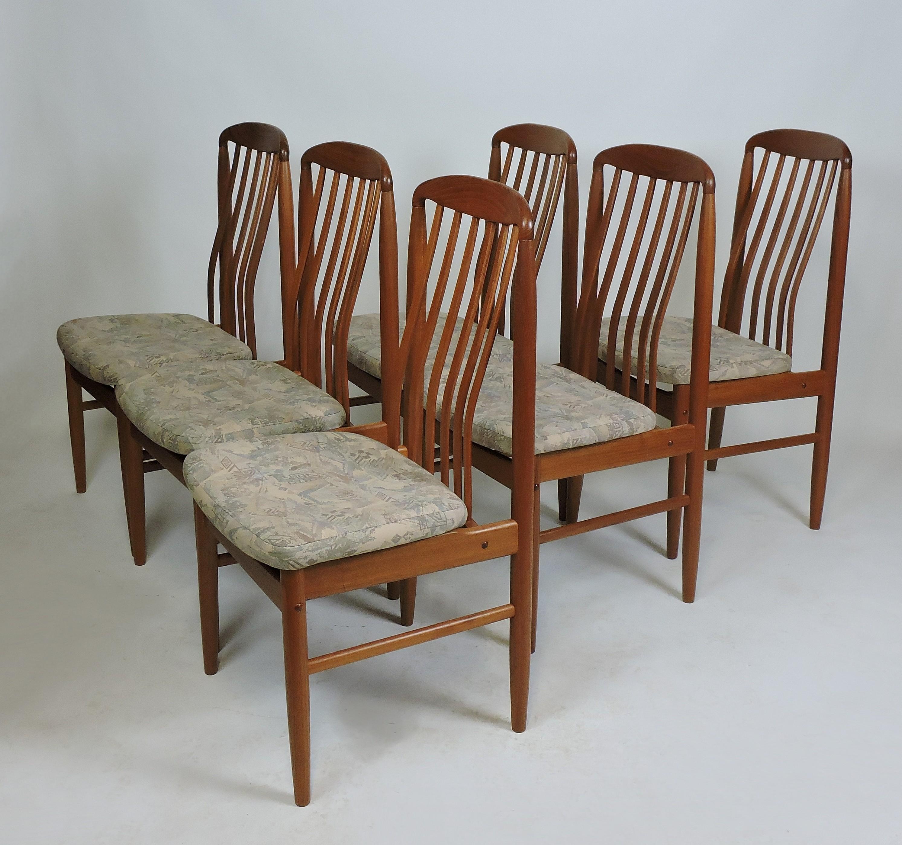 Set of six BL10 Sanne dining chairs designed by Danish designer Benny Linden. These chairs are made of solid teak with contoured spindle backs and upholstered seats. Very comfortable chairs with a graceful look. Newly reupholstered in a white