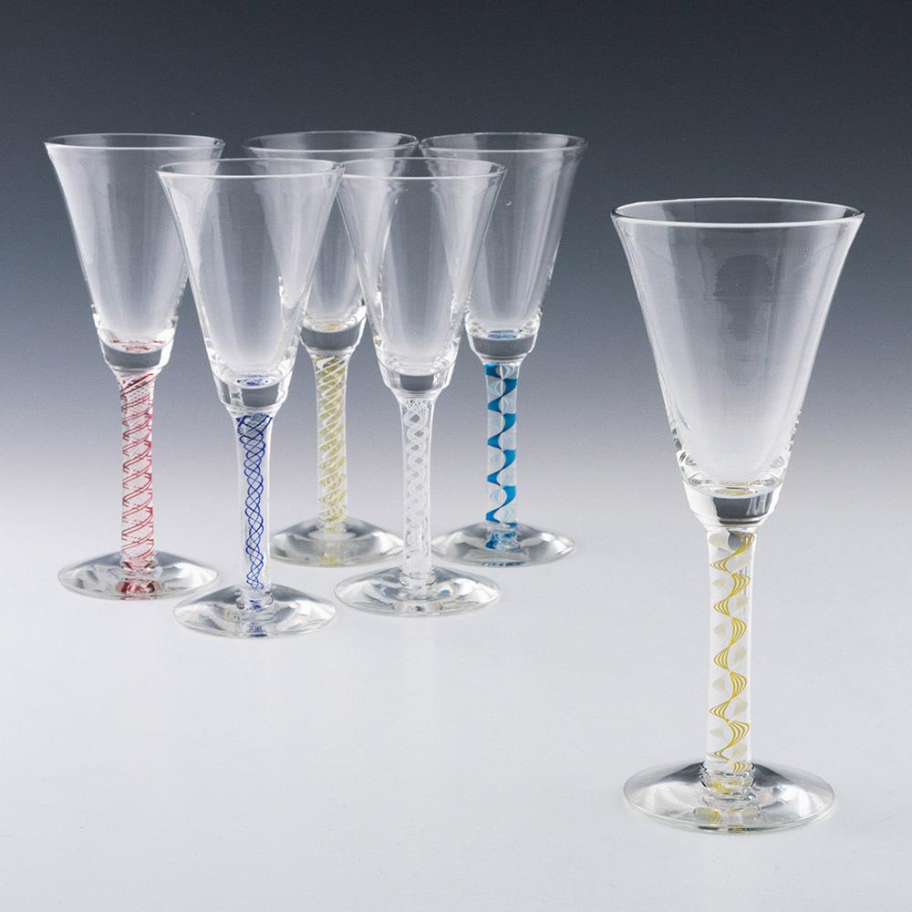 Heading : Six Mike Hunter Colour Twist Stem Wine Goblets
Period : Modern
Origin : Twist Glass Sudio, Selkirk, Scotland
Colour : Lime green, red, two shades of blue, and a double series white only
Bowl : Large round funnel
Stem : Plain
Foot :