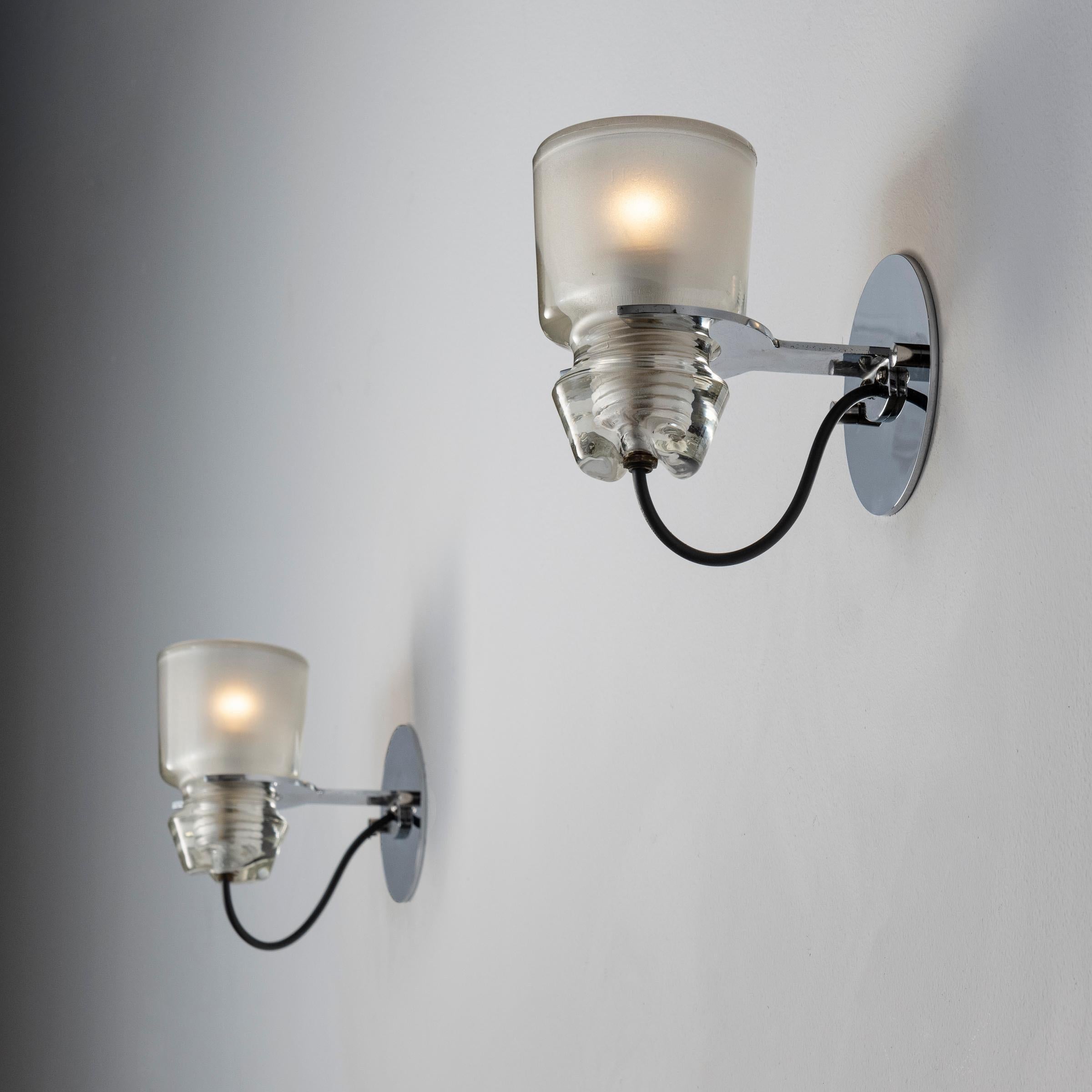 Two Model 1132 sconces by Marco Zanuso for Oluce. Designed and manufactured in Italy, circa 1960's. Crystal glass, custom chrome backplates. WIred U.S. standards. We recommend one E14 60w maximum candelabra bulbs per socket. Bulbs not included.