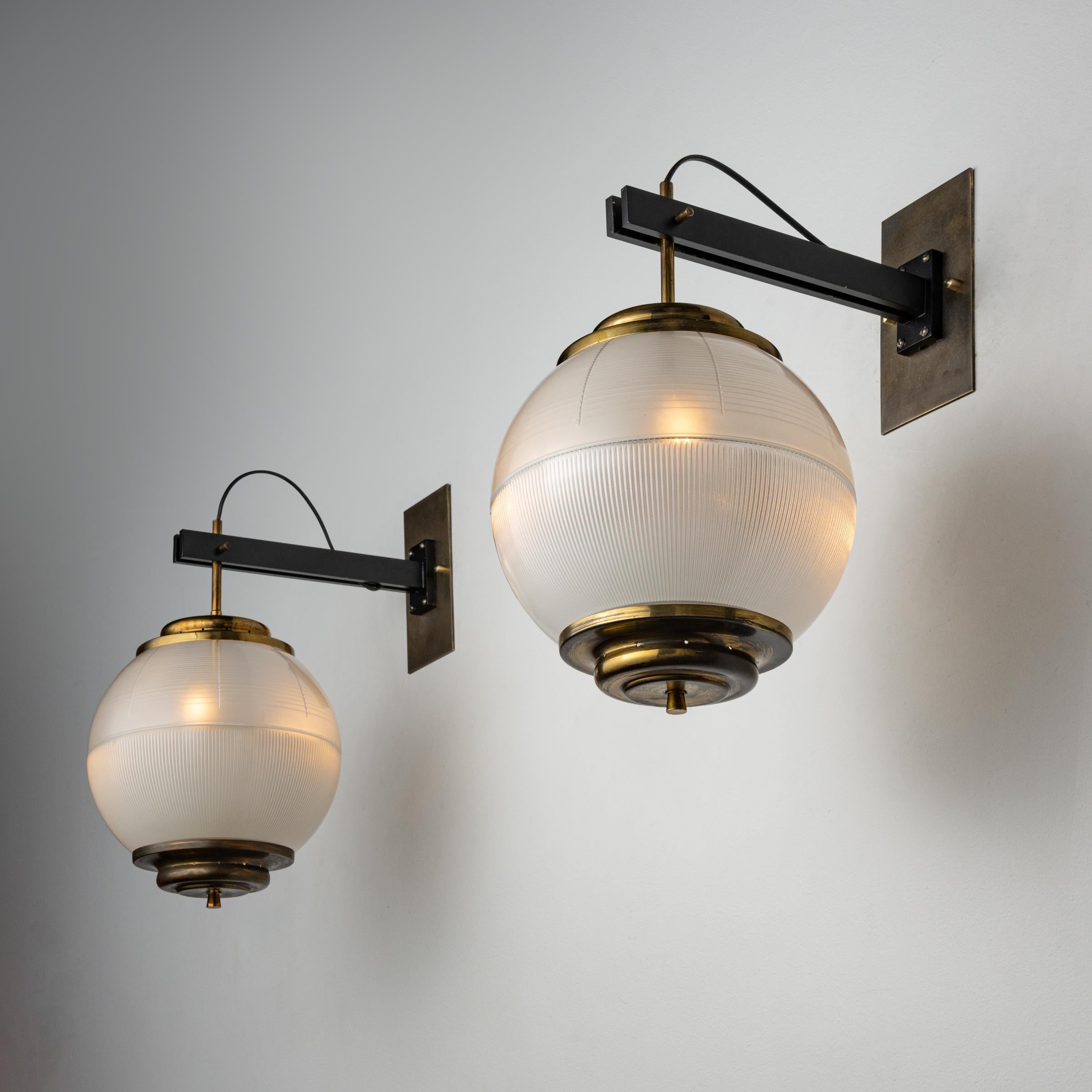 Six Model A/567 wall lights by Chiaravallotti. Manufactured in Italy, circa 1950's. Holophane glass, brass, custom brass backplates. We recommend three e14 25w maximum bulbs per fixture. Bulbs not included. Priced and sold individually, not as pairs