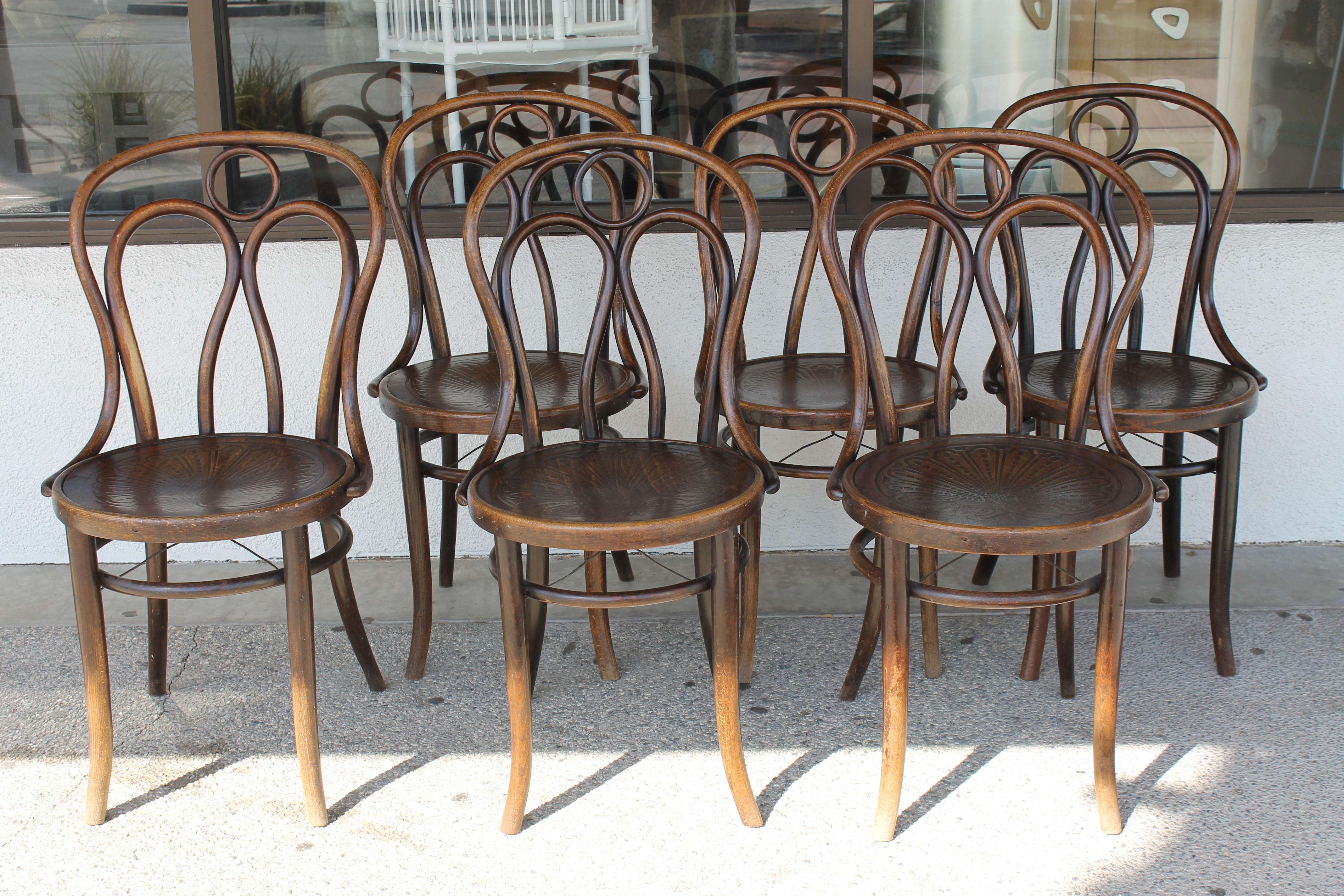 Six chairs by Mundus and J. & J. Kohn Ltd. Made in Czecho-Slovakia. After Thonet. I was told the metal support underneath these chairs were an addition at some point. Chairs measure 17.5