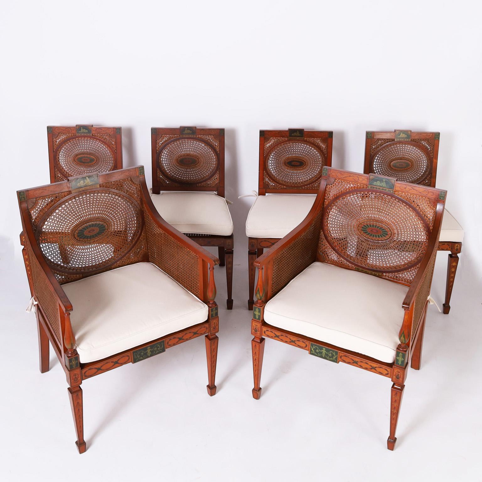 Impressive set of six dining chairs having two armchairs and four sides, crafted with mahogany in a neoclassic Adam style with painted decorations all around, featuring caned seats, sides and backs with decorated medallions, back saber legs, and