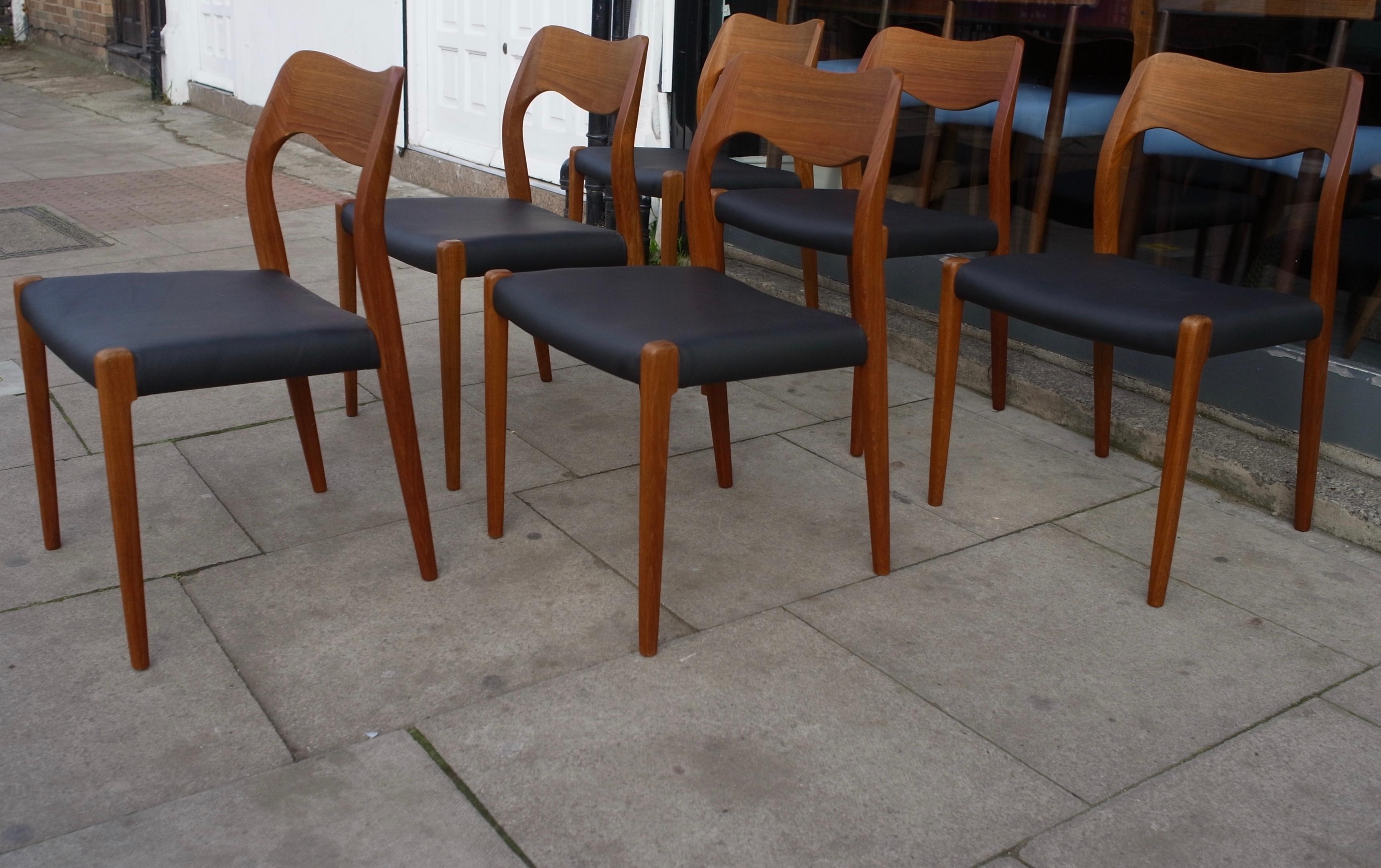 Six vintage teak framed Danish model 71 dining chairs reupholstered in quality black leather.  Designed by Niels O Moller and manufactured by J.L. Møller, these chairs are in very good vintage condition, having been restored, refurbished and