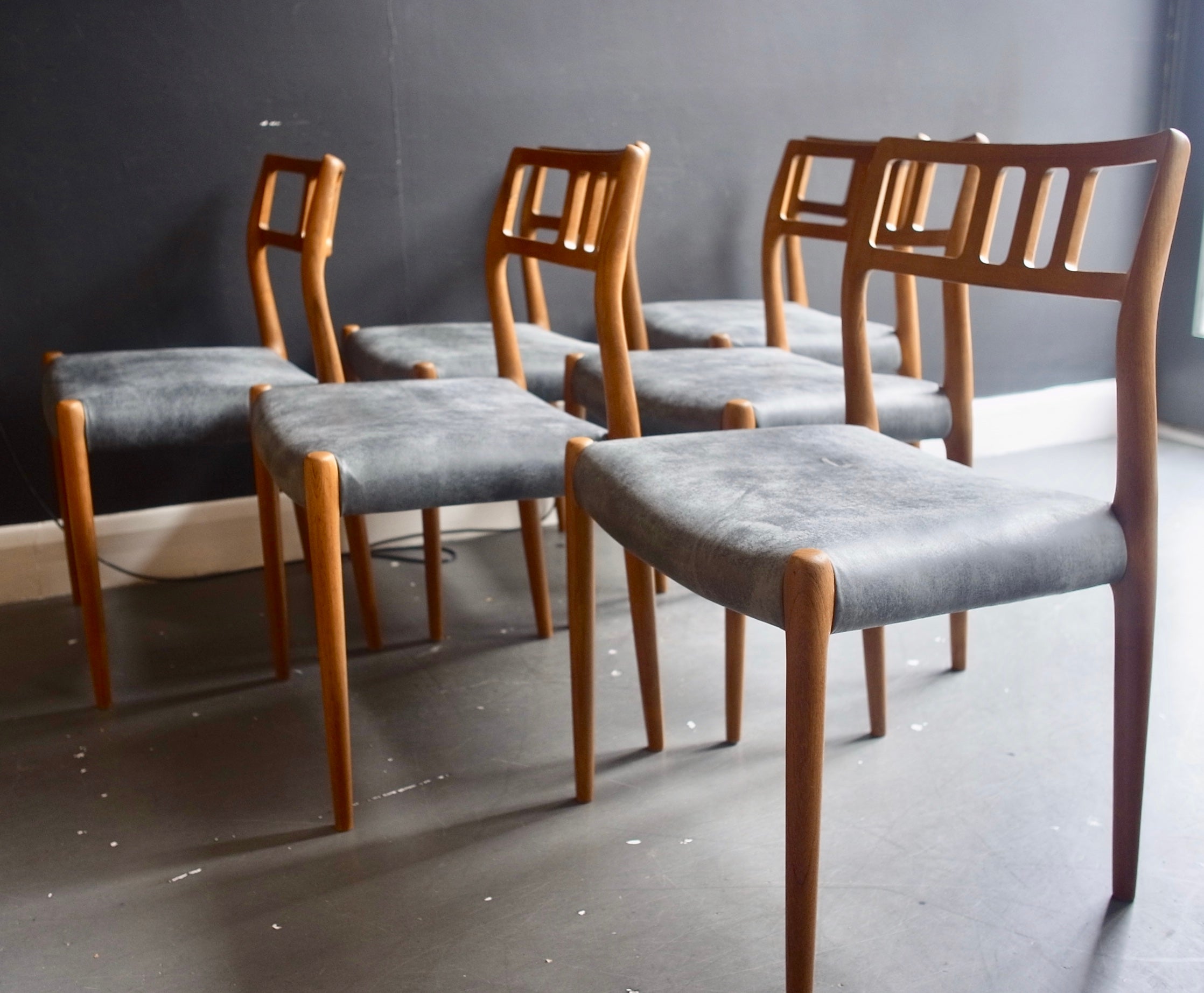 Six vintage teak framed Danish model 78 dining chairs reupholstered in quality grey leather. Designed by Niels O Moller and manufactured by J.L. Møller, these chairs are in very good vintage condition, having been restored, refurbished and