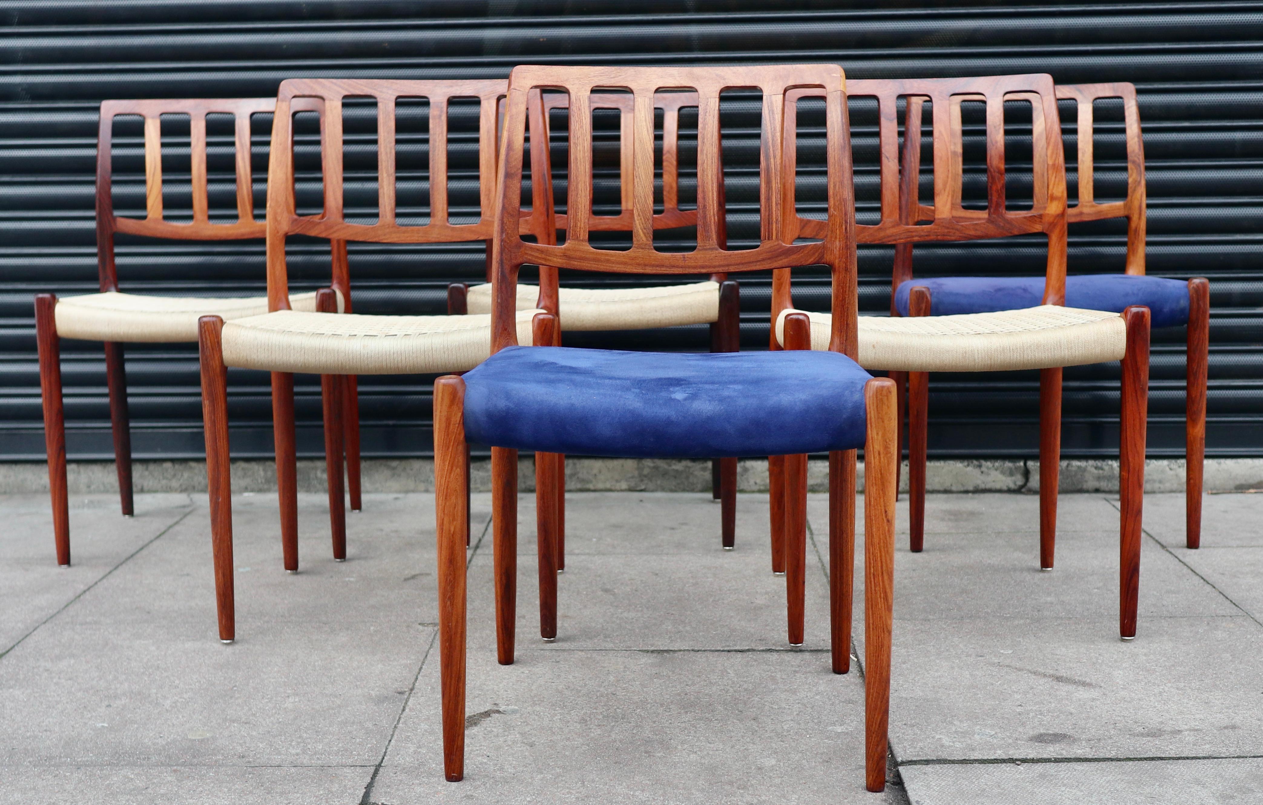 Six  vintage 1060s Rosewood framed Danish model 83 dining chairs four with woven seats, and two covered in quality blue textile. Designed by Niels O Moller and manufactured by J.L. Møller.  Although,  these chairs are in very good vintage condition,