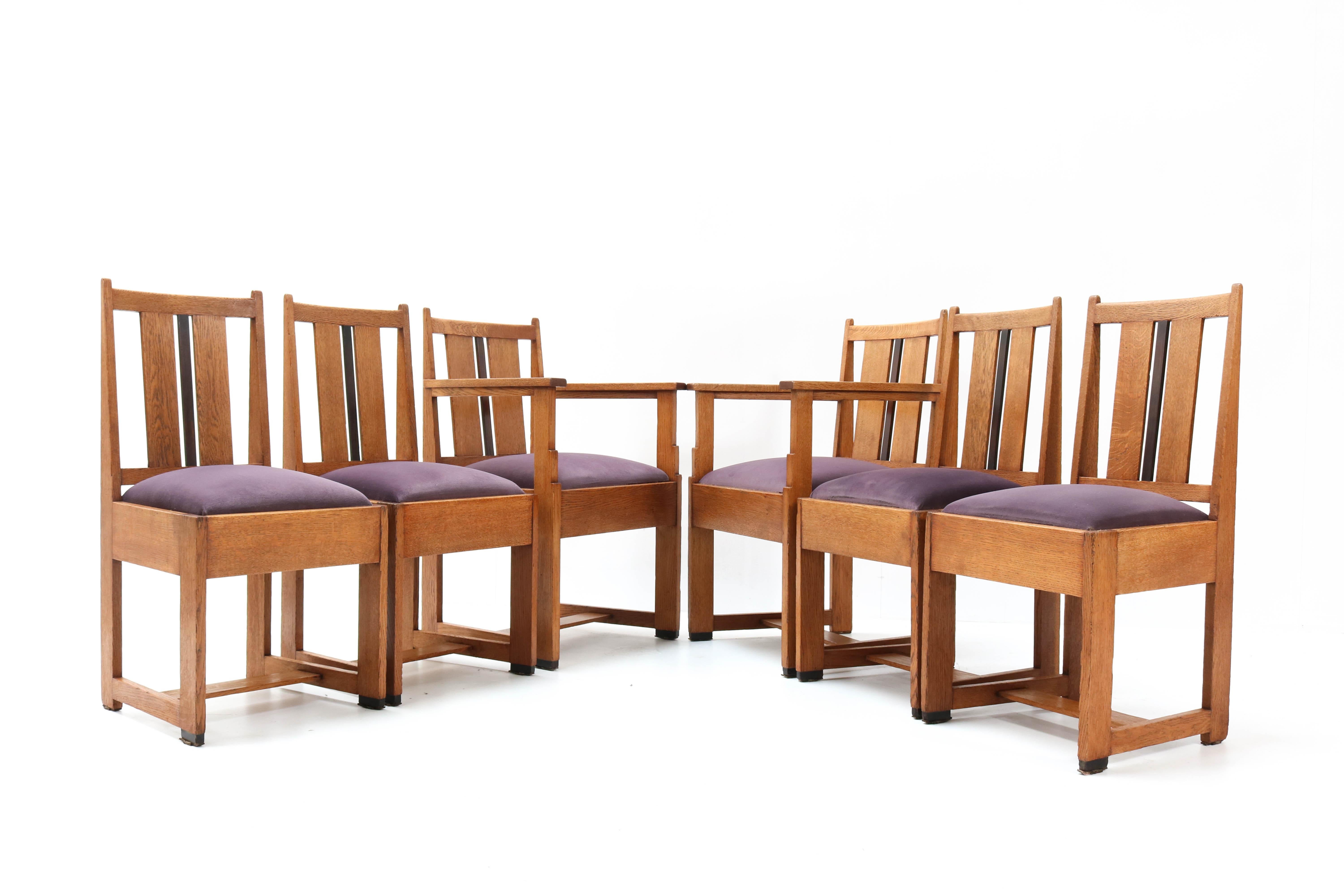 Stunning and rare set of six Art Deco Haagse School dining room chairs.
Striking Dutch design from the 1920s.
The set consists of two armchairs and four chairs.
Solid oak with solid macassar ebony.
Seats are upholstered with purple velvet