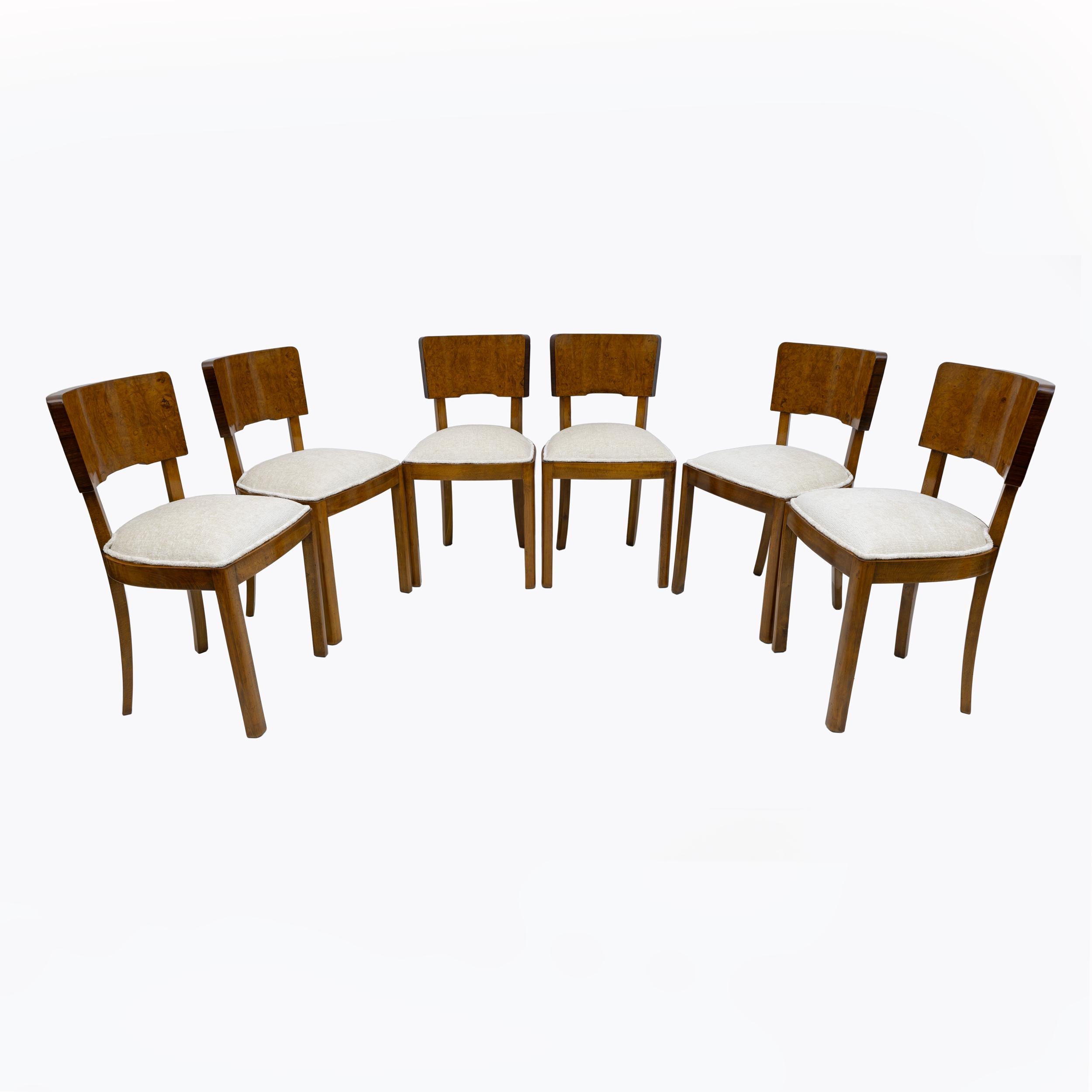 Set of 6 Art Deco dining chairs. Beech frame, with walnut burl veneer on the front of the backrest, while the rear of the backrest is veneered in rosewood. The chairs have been restored and upholstered in Bouclè fabric.
