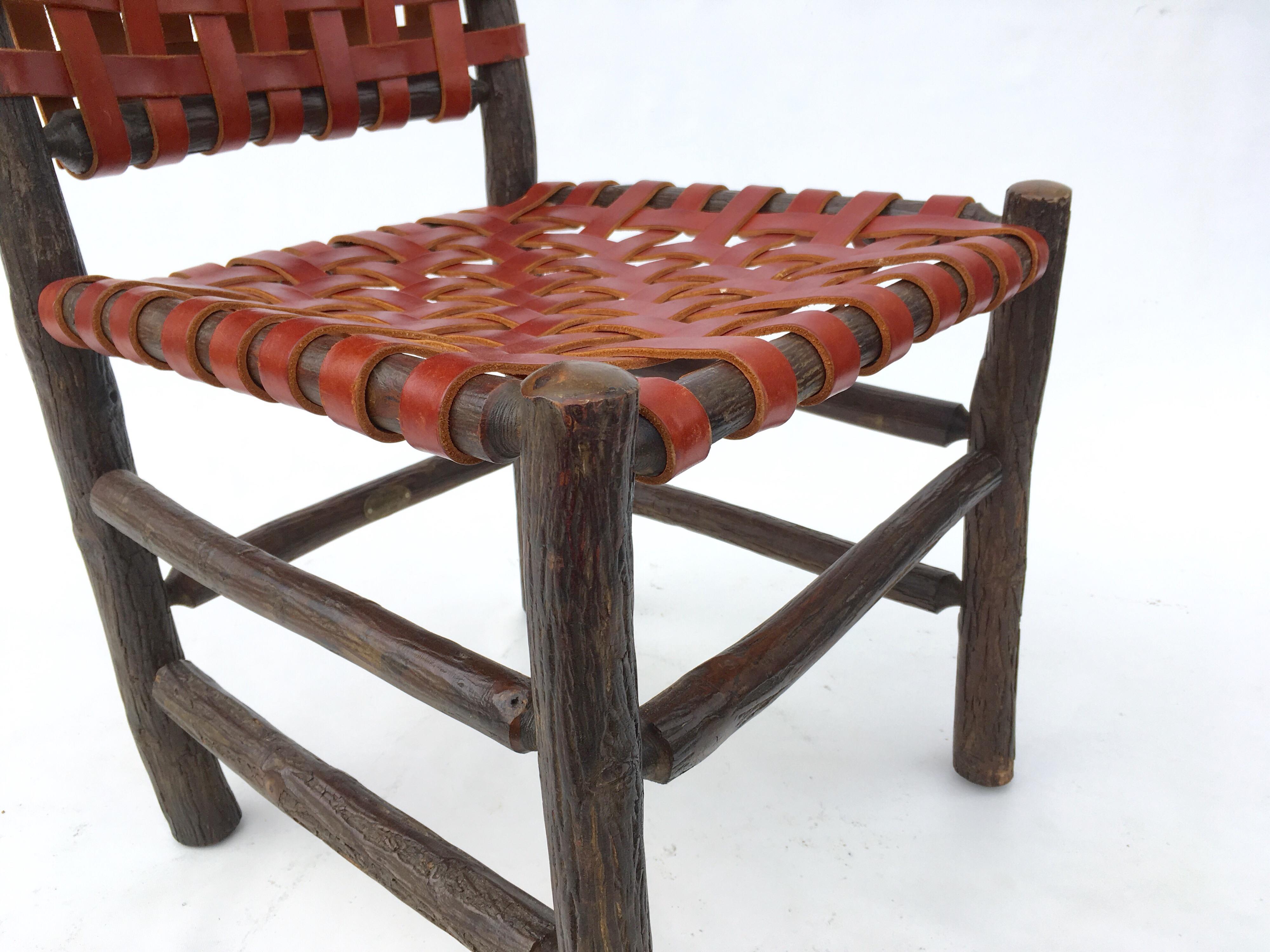 Signed Old Hickory chairs with woven saddle leather seats and backs.