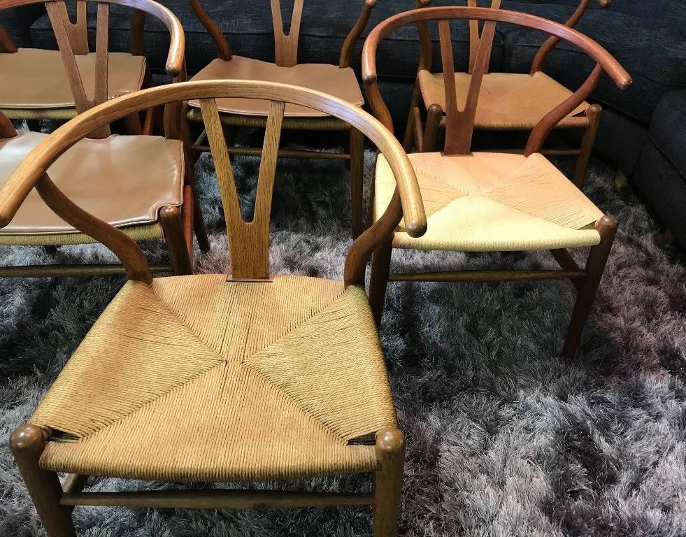 Iconic in design and aesthetic. These original six wishbone chairs by famed Danish designer Hans Wegner are all in their original finish and rope seat, with original burned in stamps (