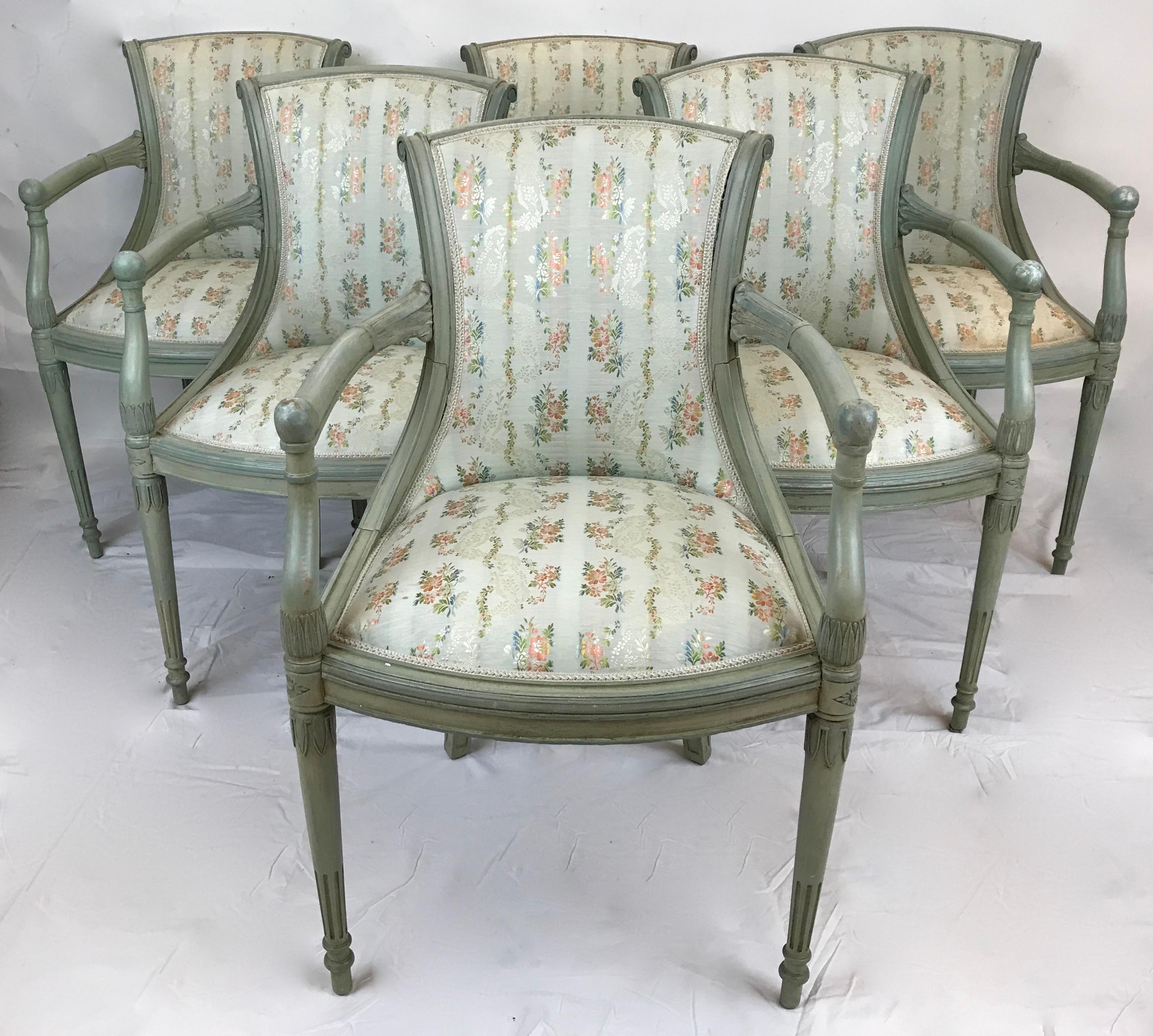 This charming set of six painted Neo-Classical style chairs feature leaf carvings and tapering fluted legs.