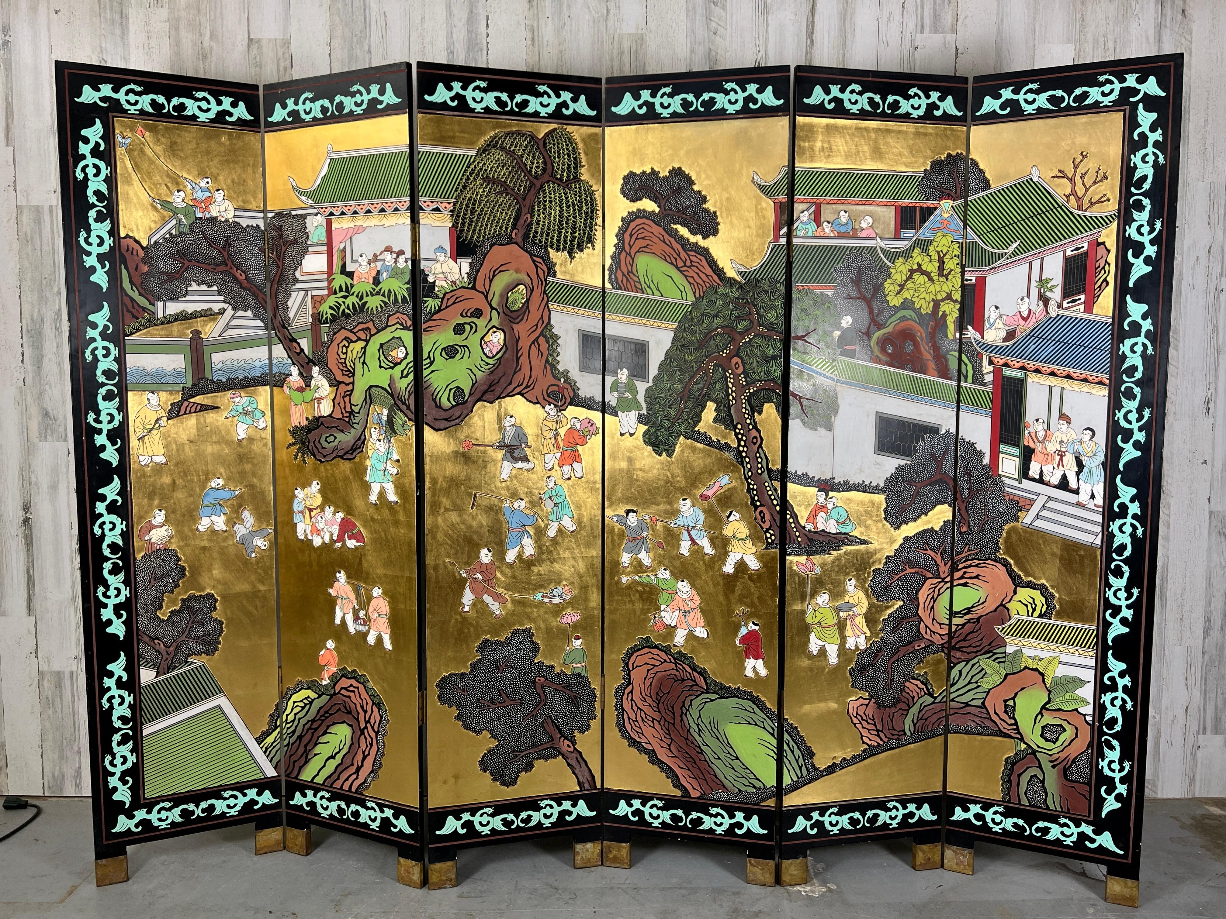 Six-panel double sided Coromandel Asian Screen lacquered in gold on one side and black on the other. The subject matter on the gold side is a festival and the black side is birds, trees, nature. This screen can be used on either side or floated in a