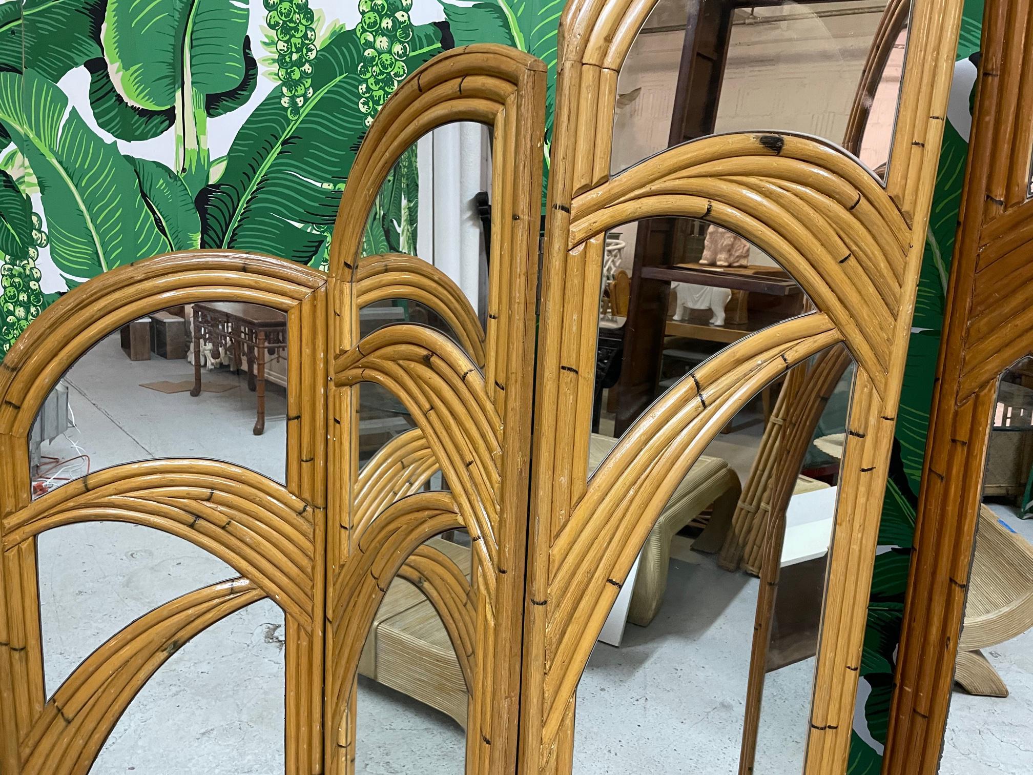 Pair of 3-panel room divider screens feature veneer of pencil reed rattan in a palm tree motif. Very good vintage condition with only minor imperfections consistent with age. Left screen is slightly lighter in color than right screen. Each panel