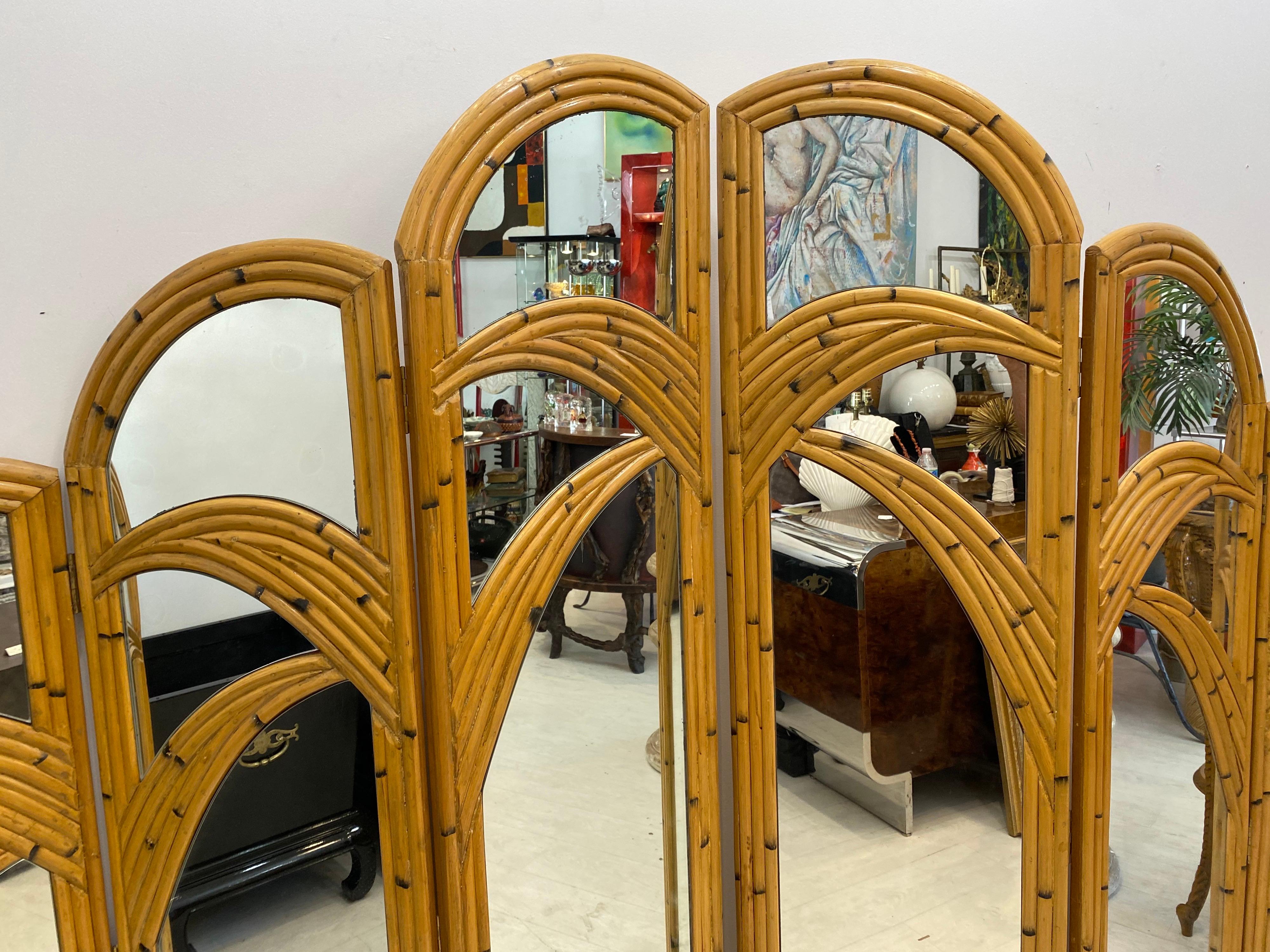 A pair of three panel room divider screens made of rattan in a palm tree motif… Very good vintage condition with only minor imperfections… Each panel measures 18 inches wide.