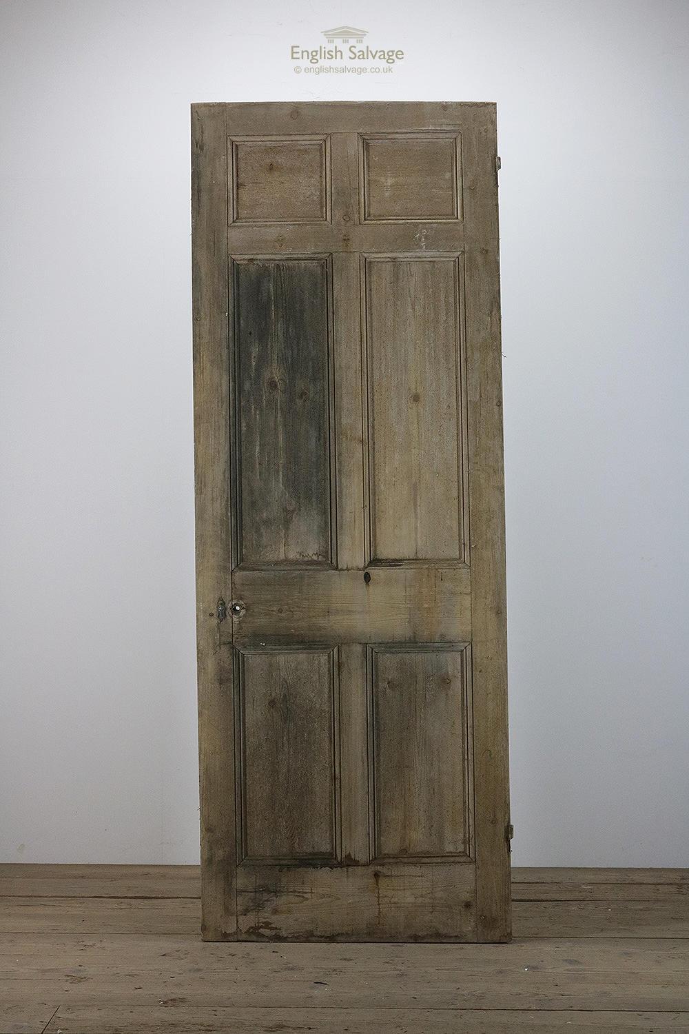 Pine six panelled door with beading both sides. Has been cut on a slant. Old fitting holes. Surface mould.