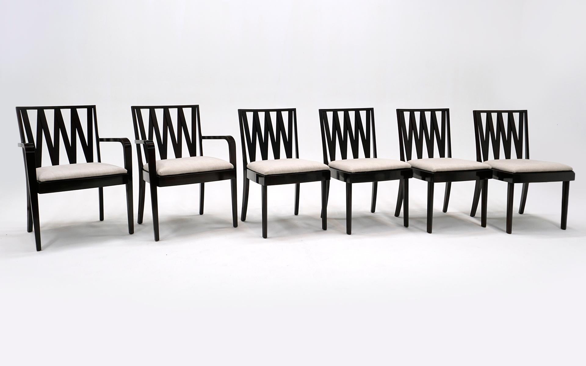 Set of 6 dining chairs, two armchairs and four side chairs, designed by Paul Frankl and made by Johnson Furniture Co., 1950s. This set has the original dark mahogany finish in very good condition with newer off white upholstered seats.