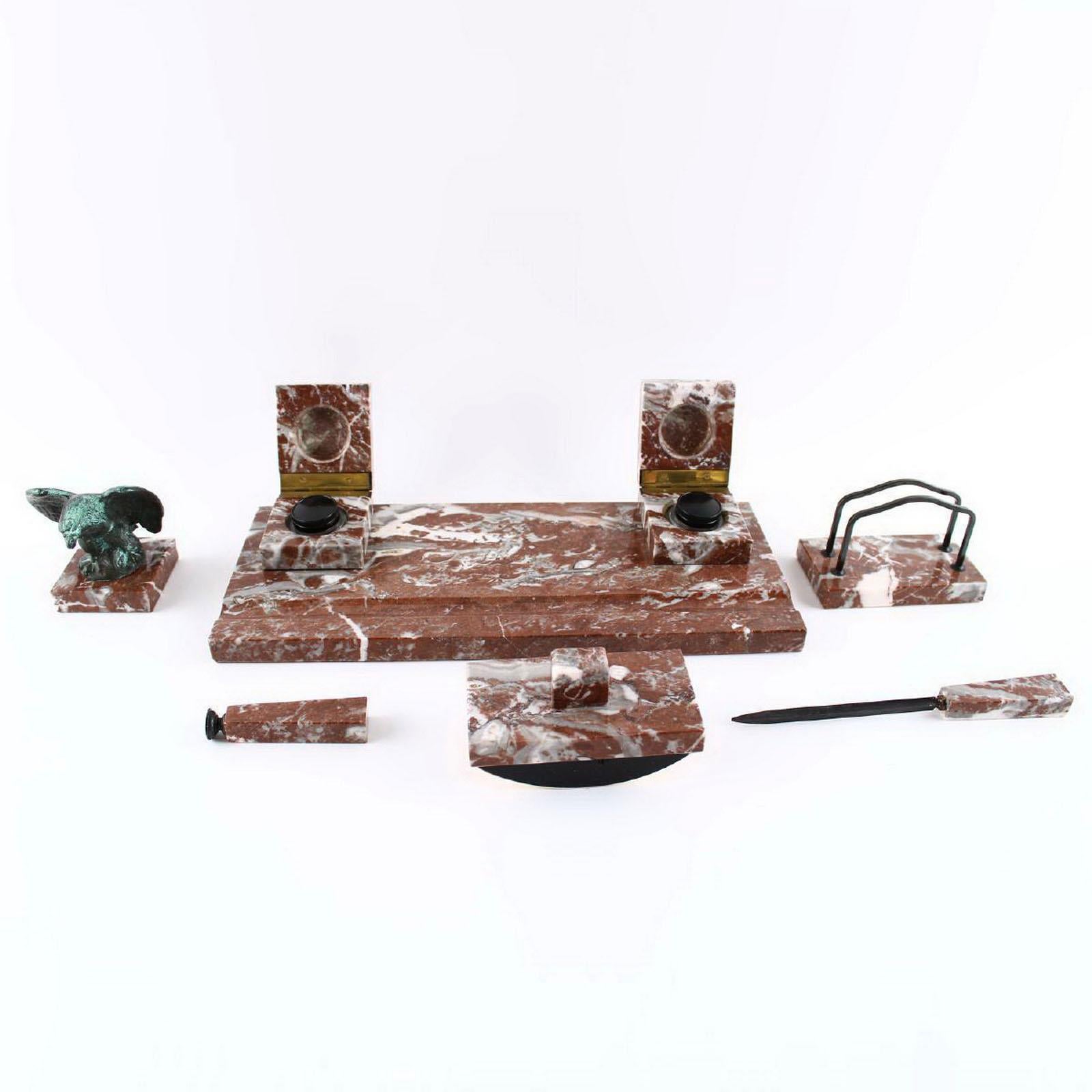 An outstanding desk set made of beautiful Italian Levanto red marble.
Comprising:
- Pen tray with two inkwell
- Letter holder
- Blotter
- Paper knife
- wax seal stamp
- Paperweight 

The glass inkwells that are original and perfect. The wax
