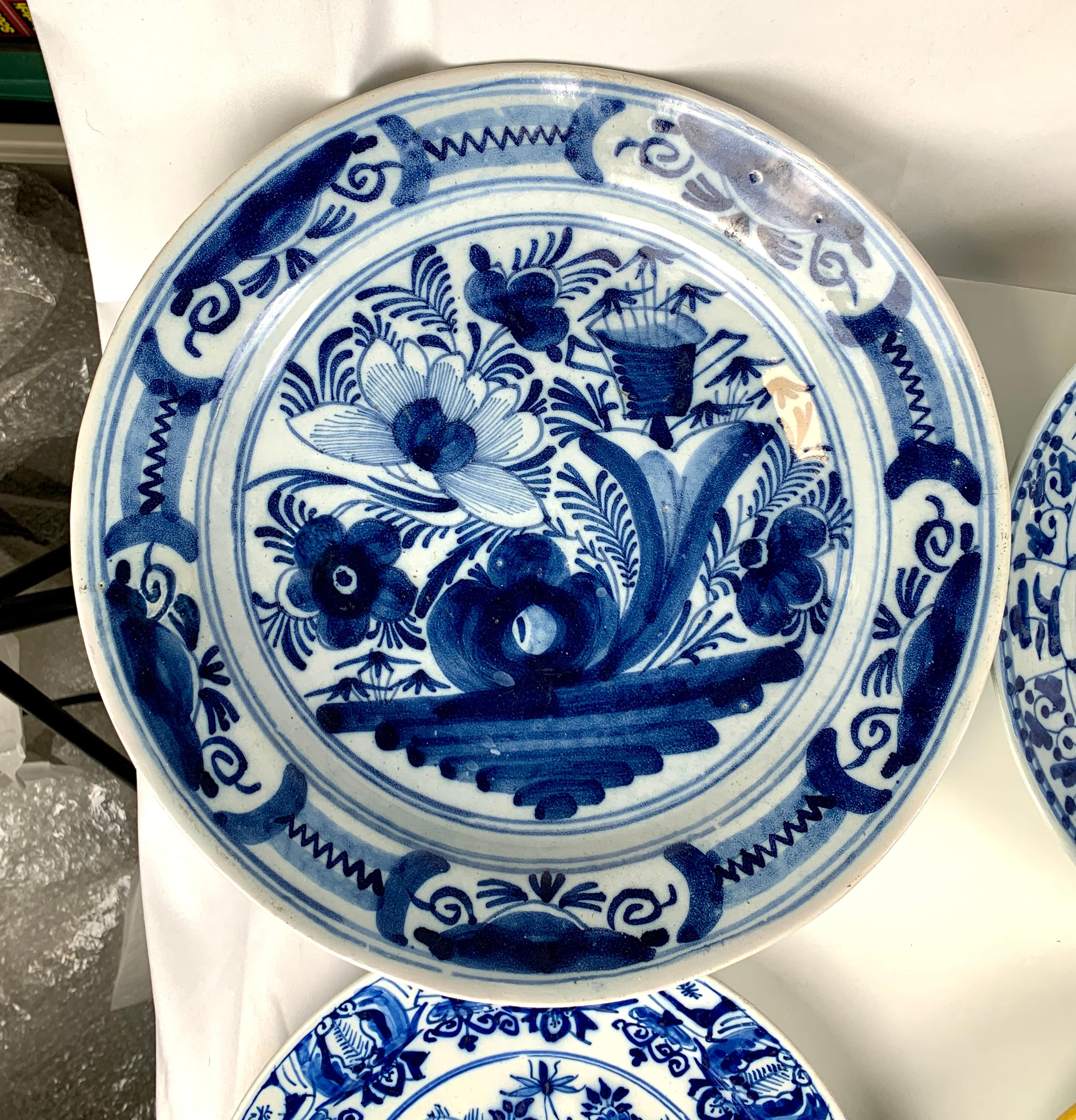 Item 1) Top left
A Dutch Delft blue and white charger Made circa 1800
Showing a waterside scene with a waterlily and in the foreground 