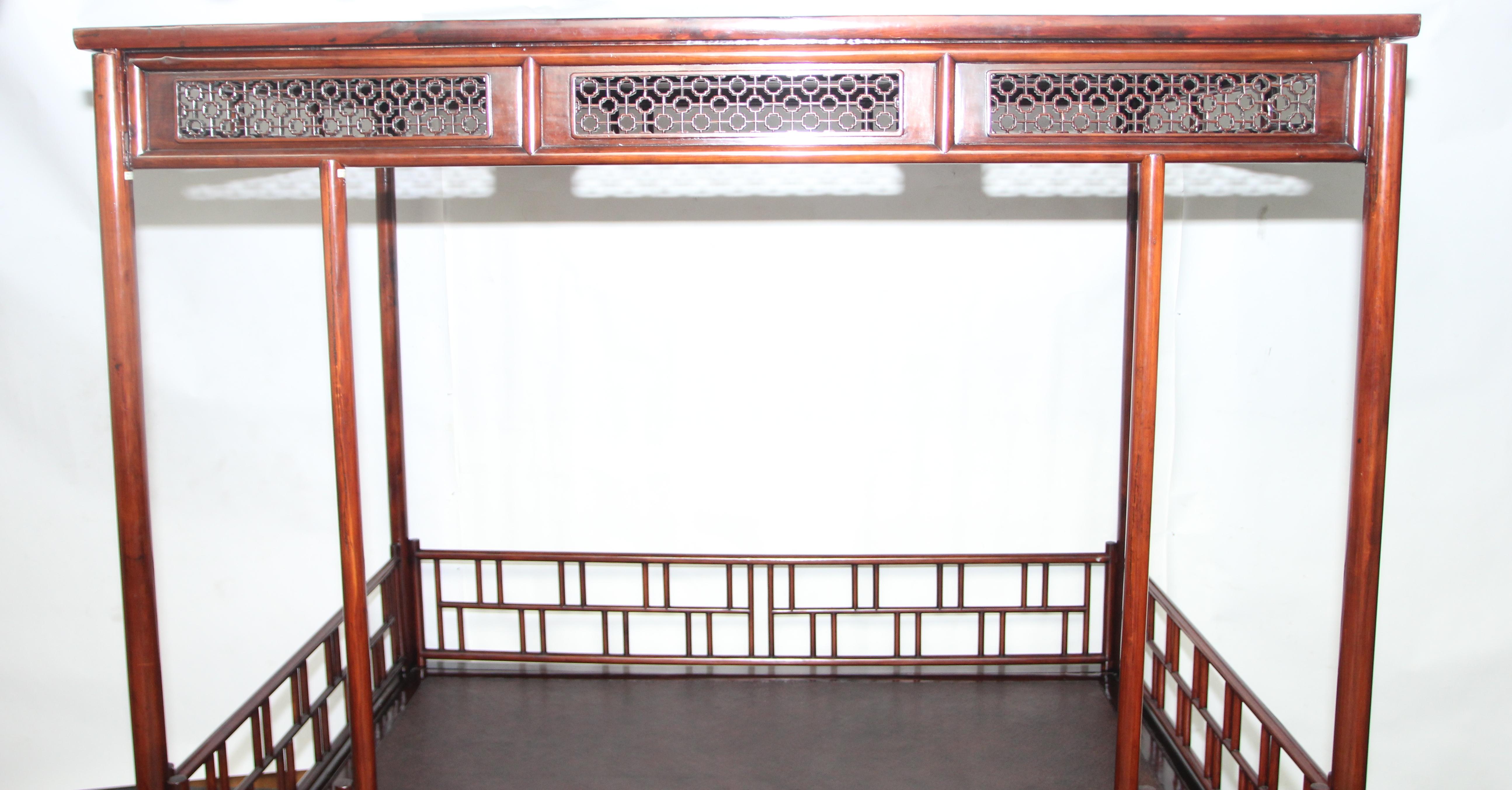 Fine six-posted canopy bed. 
The bed base with a rounded-front edged frame and a caned top, supported on circular-sectioned legs decorated with straight stretchers and vertical struts, the six posts braced on the back and sides by railings of