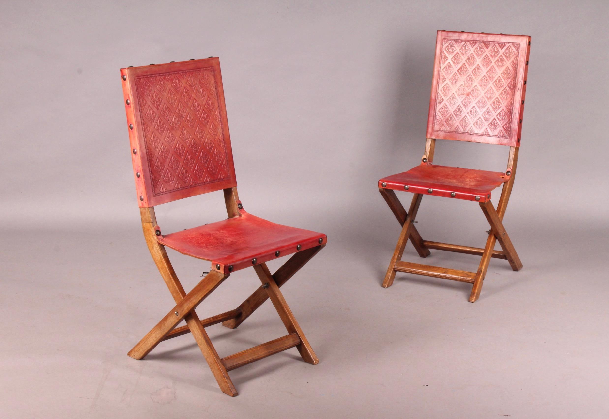 Six red leather and wood Jacques Adnet style folding chairs, 
the leather is little torn on two chairs and must be restored see photo.