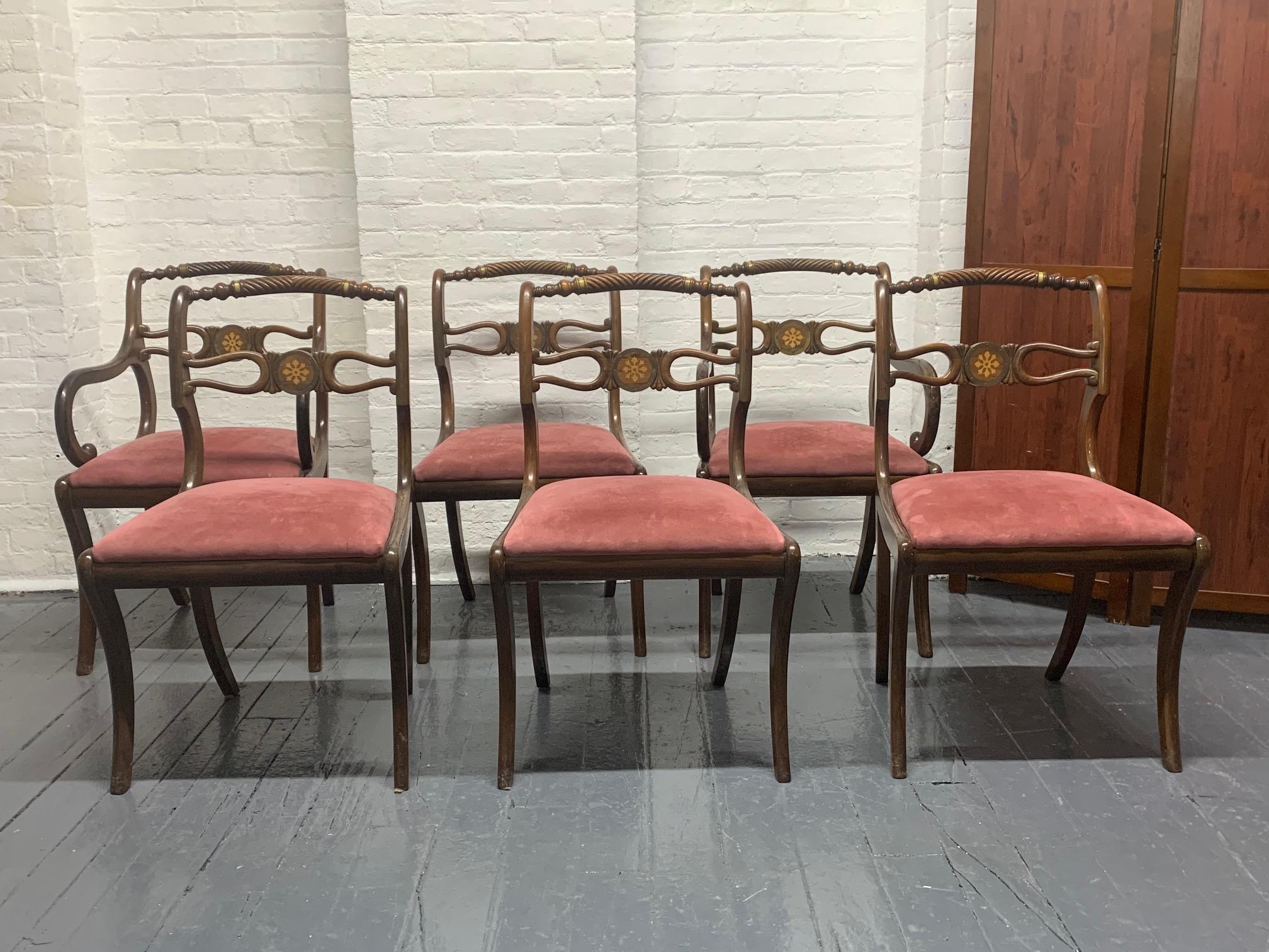 Six rosewood English Regency style dining room chairs. The seats are suede upholstery, have brass trimming and the back of the chairs has inlay pattern. 

Armchairs measures: 34 H x 20.5 D x 21 W. Arm height 25.5
Without arms: 34.5 H x 21 W x 20