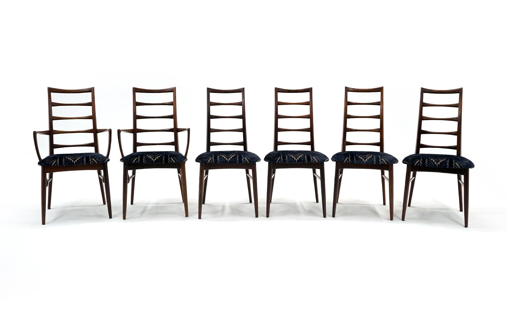 Set of 6 Mid-Century Danish Modern dining chairs in Brazilian rosewood designed by Niels Kofoed. Two armchairs and six armless chairs. Fine examples of this design. The set is in very good condition. See one photo where an inside leg has an area of