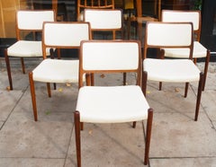 Six hardwood Niels Moller Model 80 Chairs, with cream vinyl upholstery