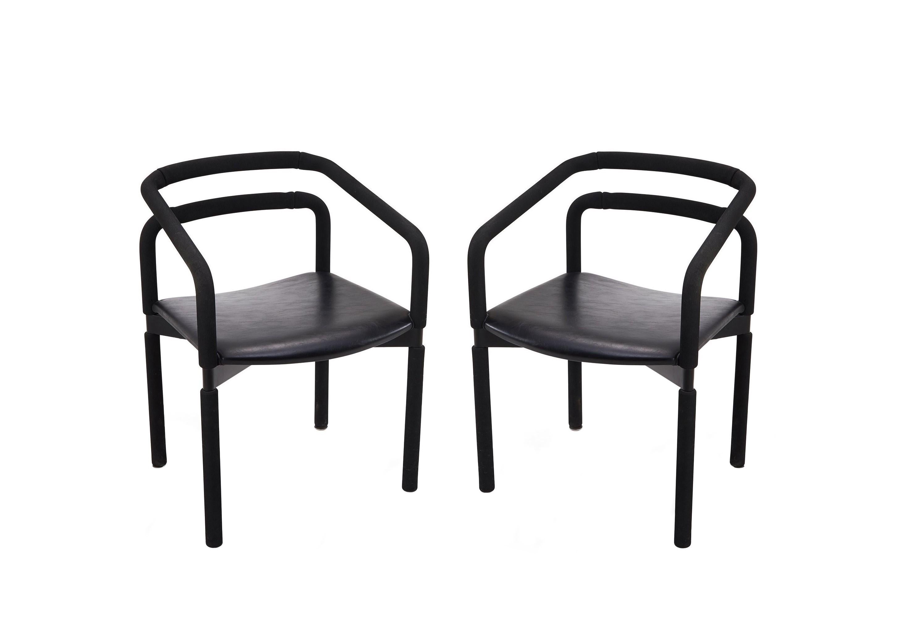 Fabulous set of six bold black armchairs by Metro for Steelcase designed by Brian Kane. These sleek vintage chairs are made of black steel encased in EPDM rubber tubing with comfortable black leather seats and offer a satisfying grip. In good ready