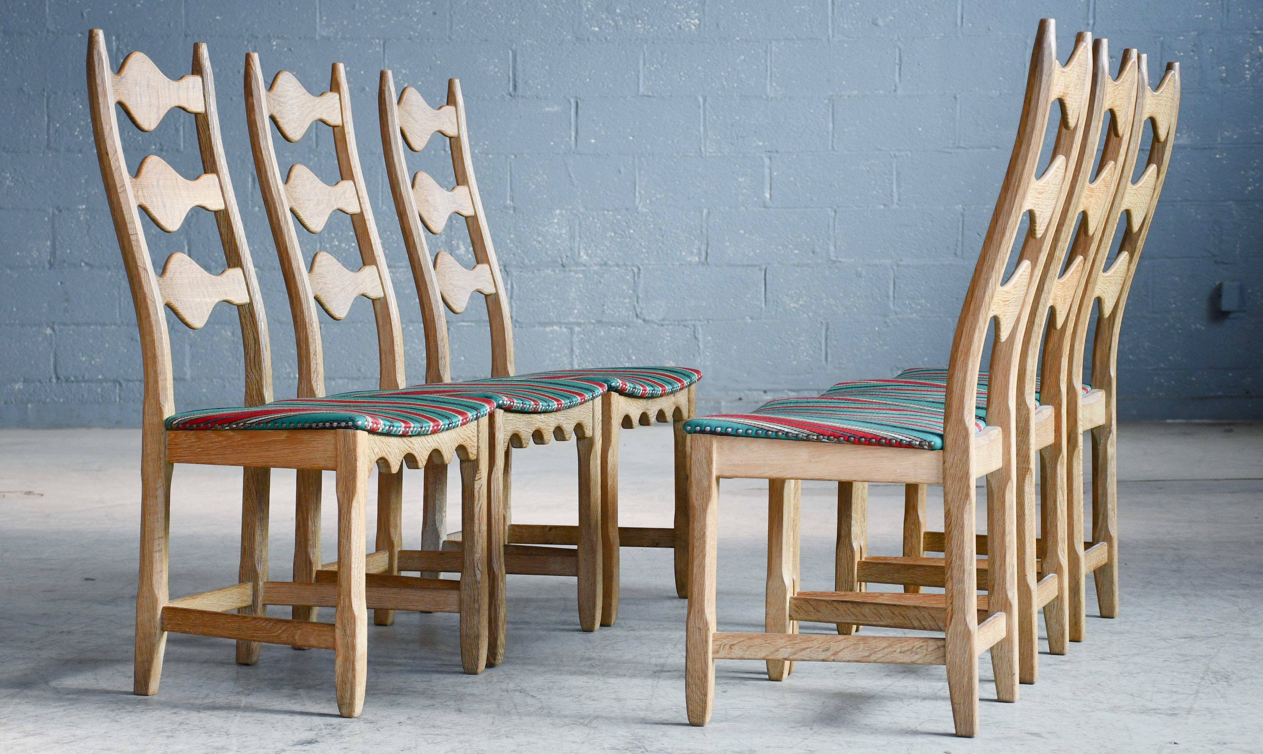 Set of 6 Danish oak dining chairs by Henning Kjærnulf made in the 1960's. Very typical of Kjærnulf.'s designs as he was known for combining the midcentury style with more brutalist rustic designs taking inspirations from medieval and Viking era