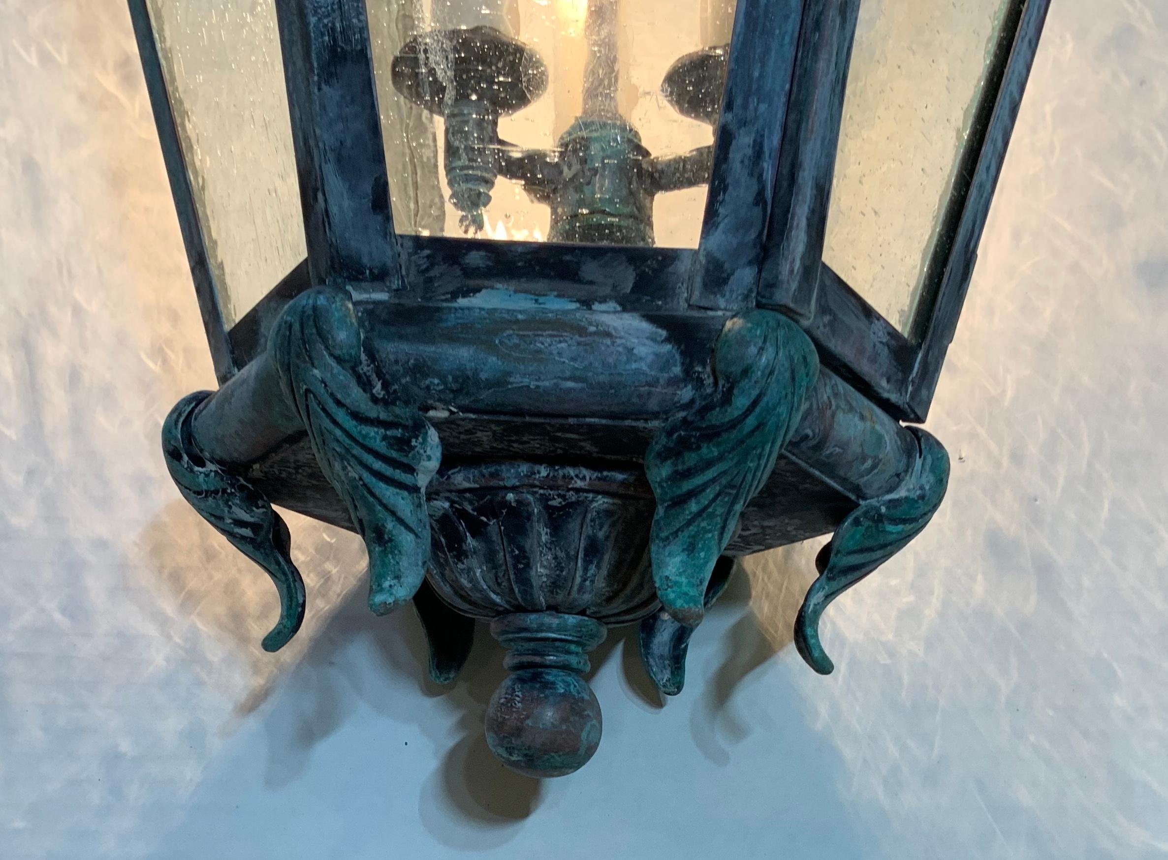 Beautiful patina, six sides hanging lantern made of solid brass, Seeded glass, electrified with three 60/watt lights, decorative and ready to use .
Brass canopy and chain included.