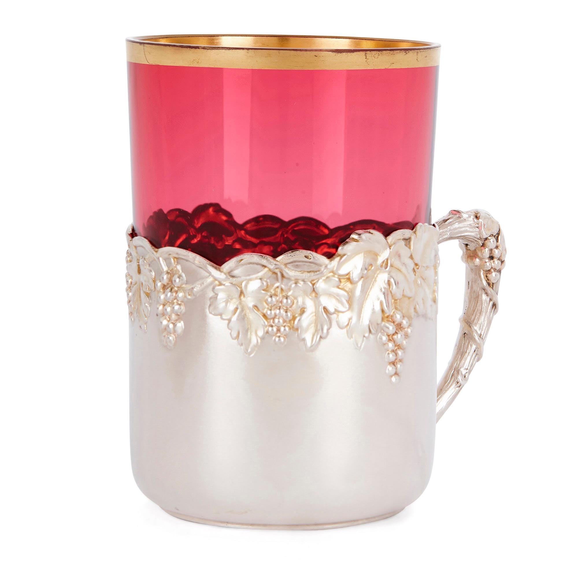 This beautiful drinking set was created in Germany in the early 20th century, circa 1900. The six cups will make an elegant addition to a collection of drink- or tableware. 

Each item is composed of a silver cup with a single handle, which is