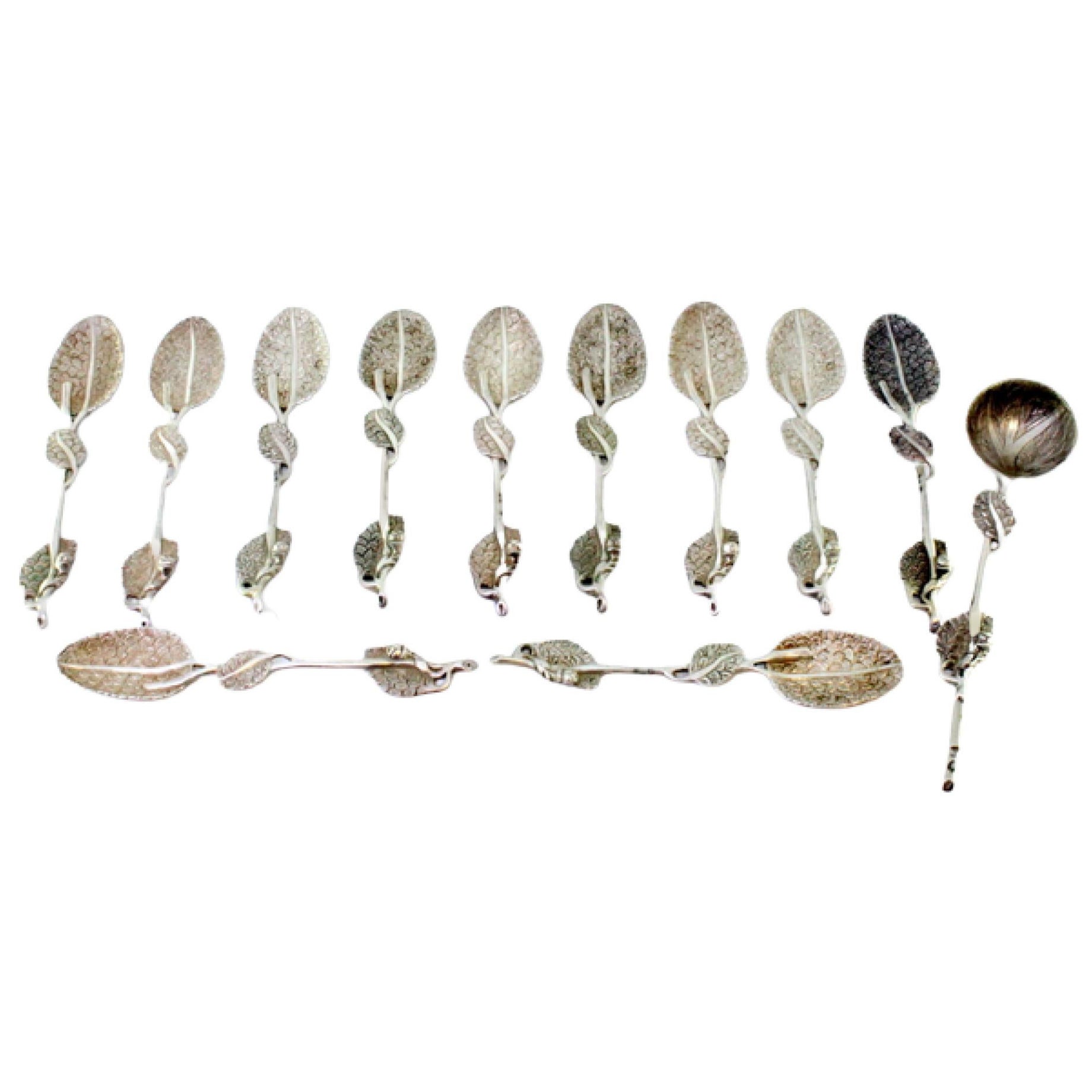 Six silver spoons and sugar shovel with raised handles and ribbed shell bowls