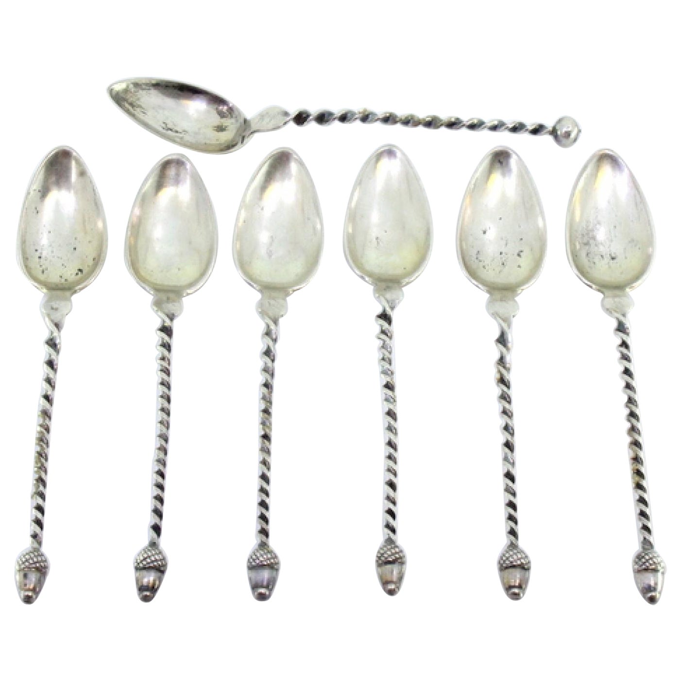 Six silver teaspoons and sugar scoop with twisted handles and acorn appliqués