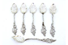 Six silver teaspoons with reliefs and ribbed leaf-shaped ladle