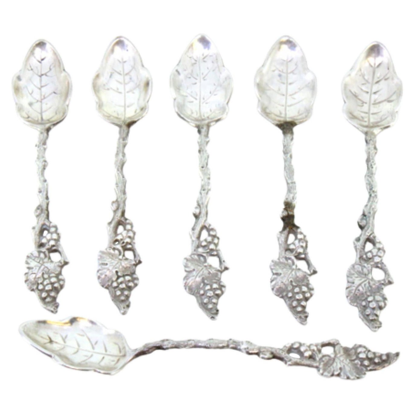 Six silver teaspoons with reliefs and ribbed leaf-shaped ladle