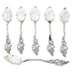 Six silver teaspoons with reliefs and ribbed leaf-shaped ladle