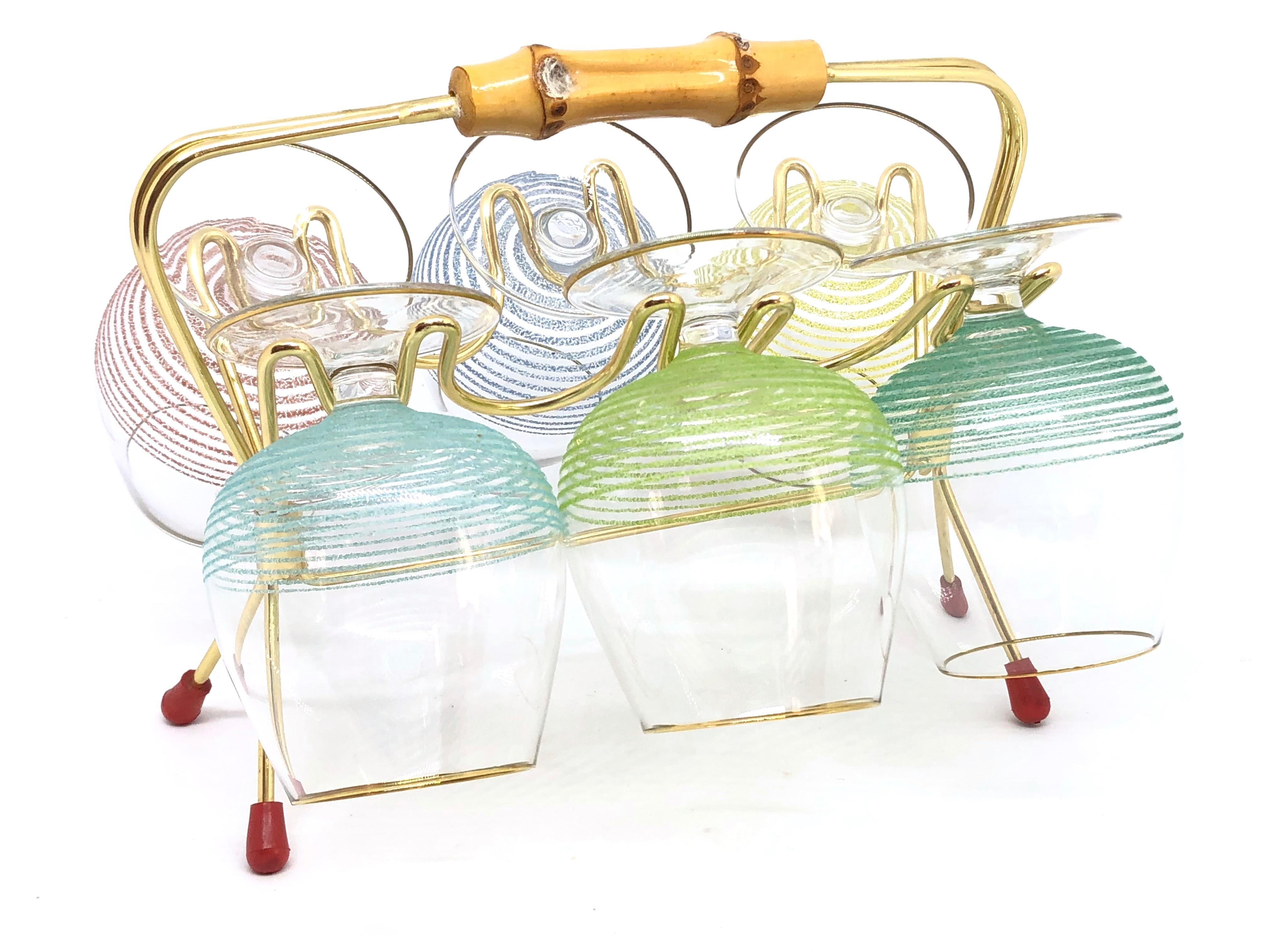 A Mid-Century Modern Barware caddy or display Stand. It holds six cognac snifters glasses. It is made of brass wire, Bamboo handle and mouth blown glasses. Each glass is approx. 3 ½