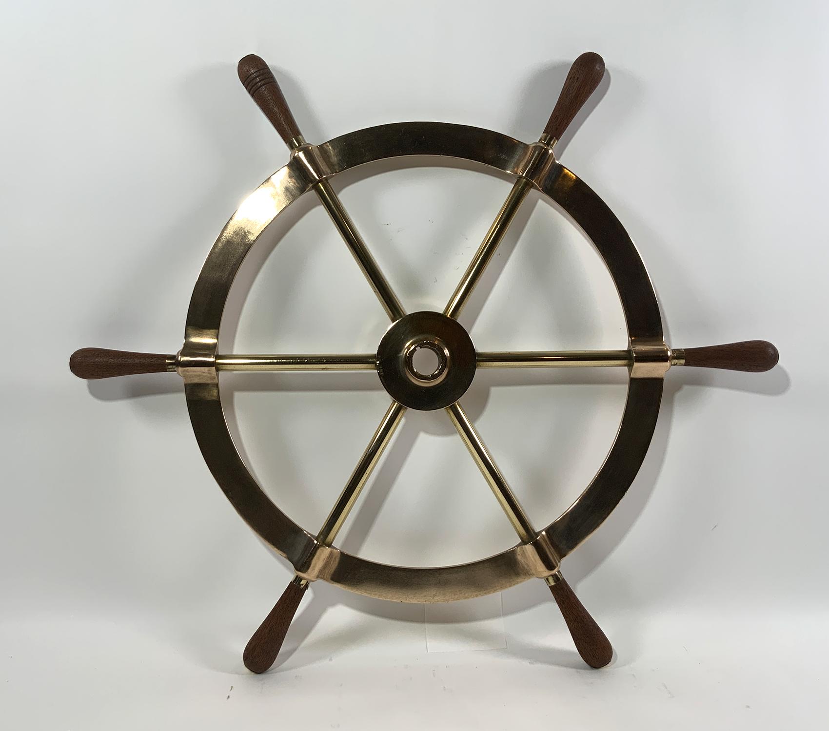 Exceptional yacht wheel, very heavy. With wood handles. Center hub has a keyhole. This is as good as they come.

Weight: 23 LBS
Overall Dimensions: 31