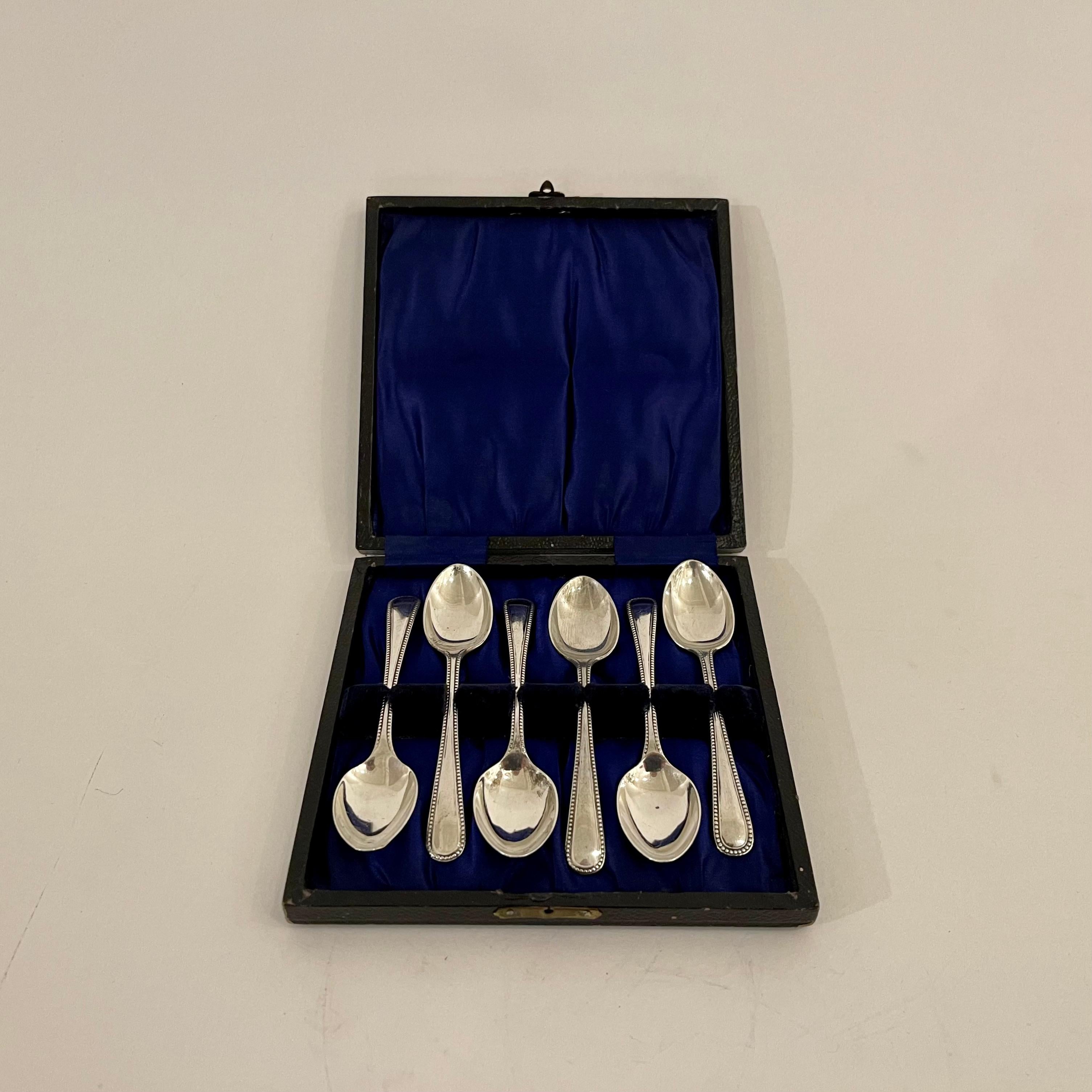 This set of six solid sterling silver teaspoons from 1926, by Joseph Lyddiatt of Birmingham, are presented in the original black leather box in which they were sold. The interior of the box is lined in a deep blue silk-satin fabric which