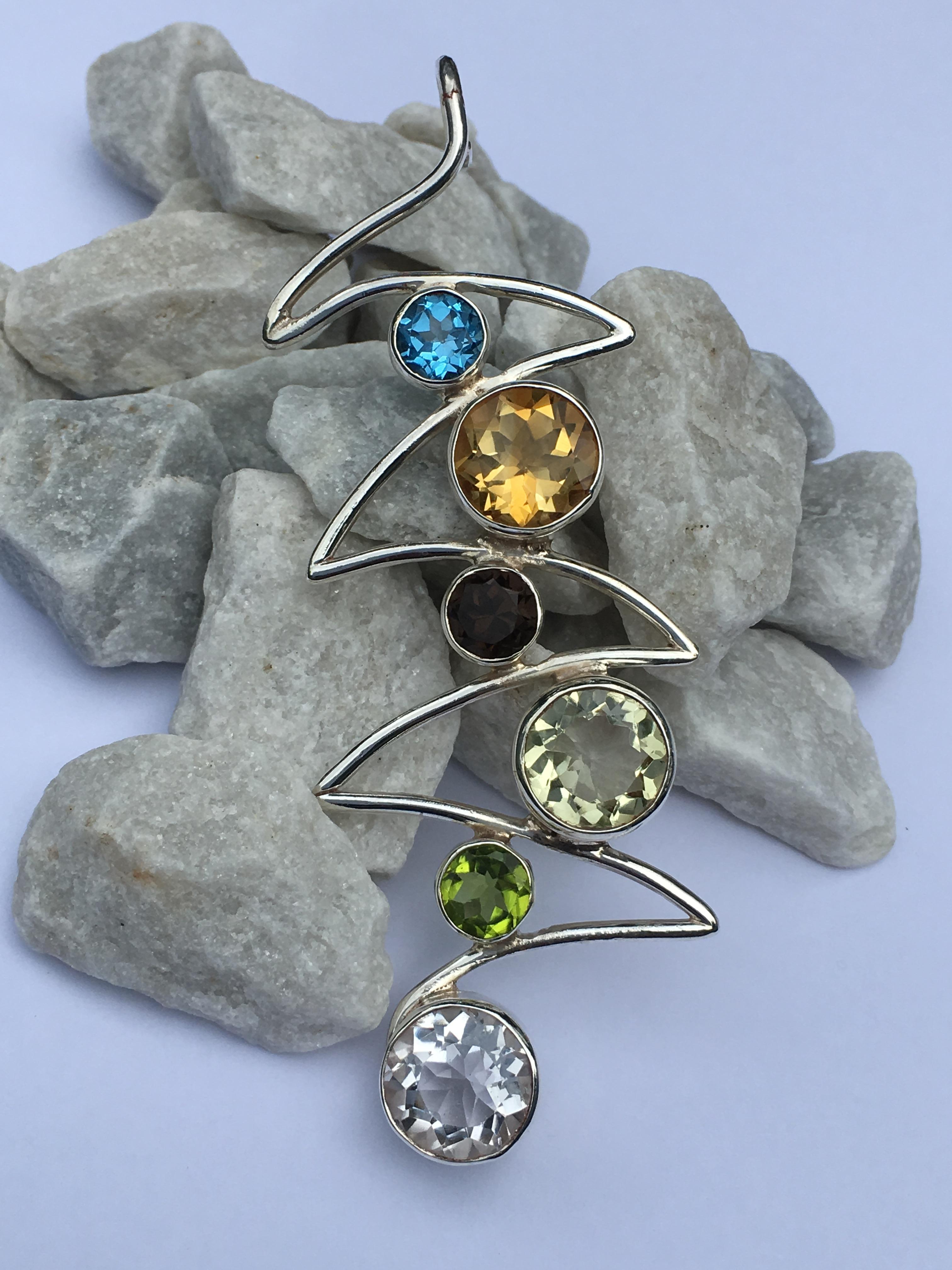 Natural blue topaz. smokey topaz and Peridot are 7 mm round and Citrine, lemon quartz and rock crystal are 11 mm round stones. All stone are hand cut and polished . This  wave pendant is also called chakra pendant.
This pendant is one of a kind and