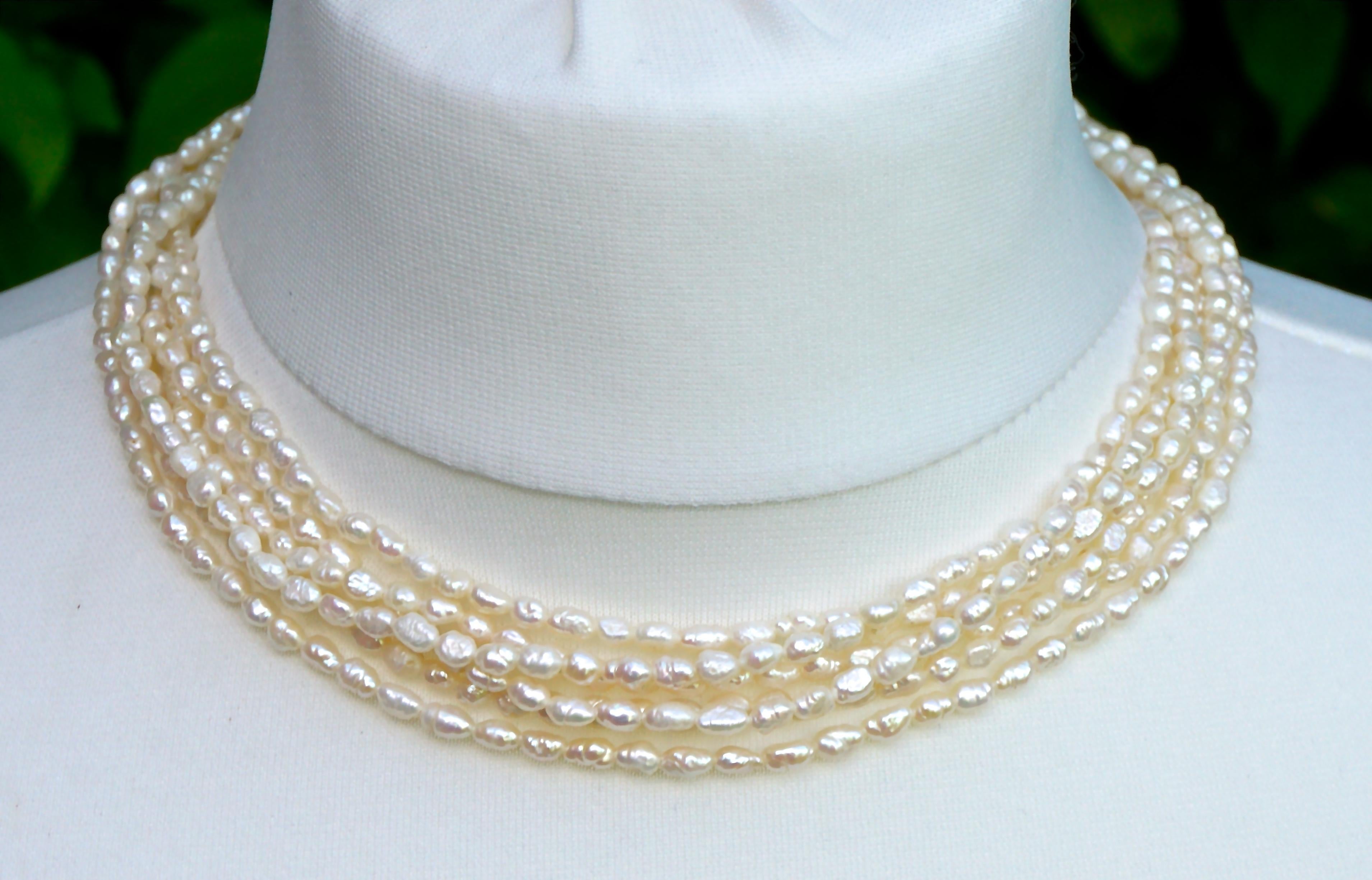 Six strands of baroque rice pearls, that can be worn twisted or loose, with a simple silver gilt clasp. The necklace is length 43.5cm / 17.1 inches, and each pearl is approximately length 5mm / .19 inch. The pearls have a lovely ivory colour and