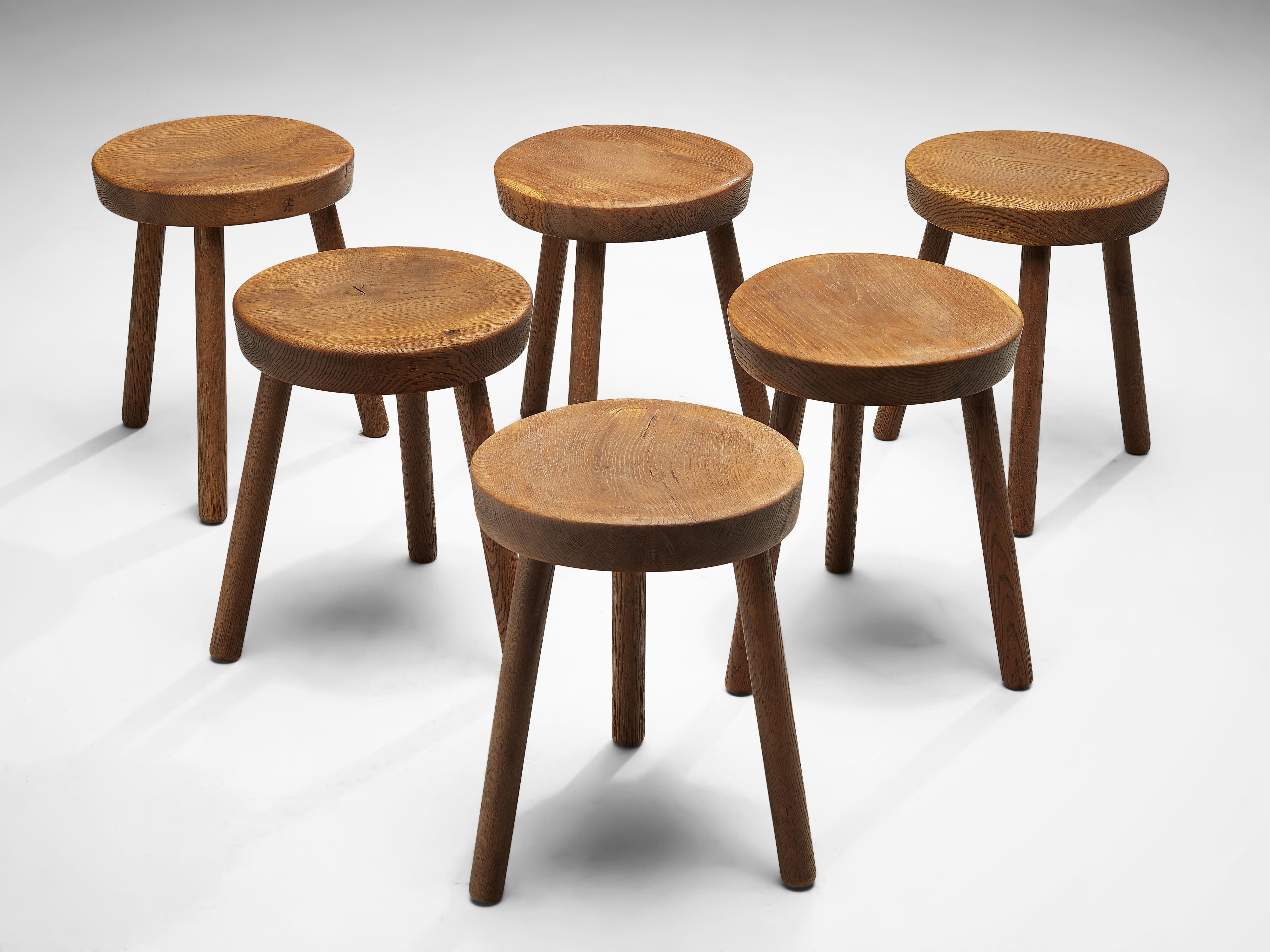Tripod stools or side tables, solid oak, Switzerland, 1960s-1970s.

Beautiful crafted oak stools originating from the exhibition center in St. Gallen, Switzerland. The seat is handcrafted to have a small dip for better comfort. With their simple yet