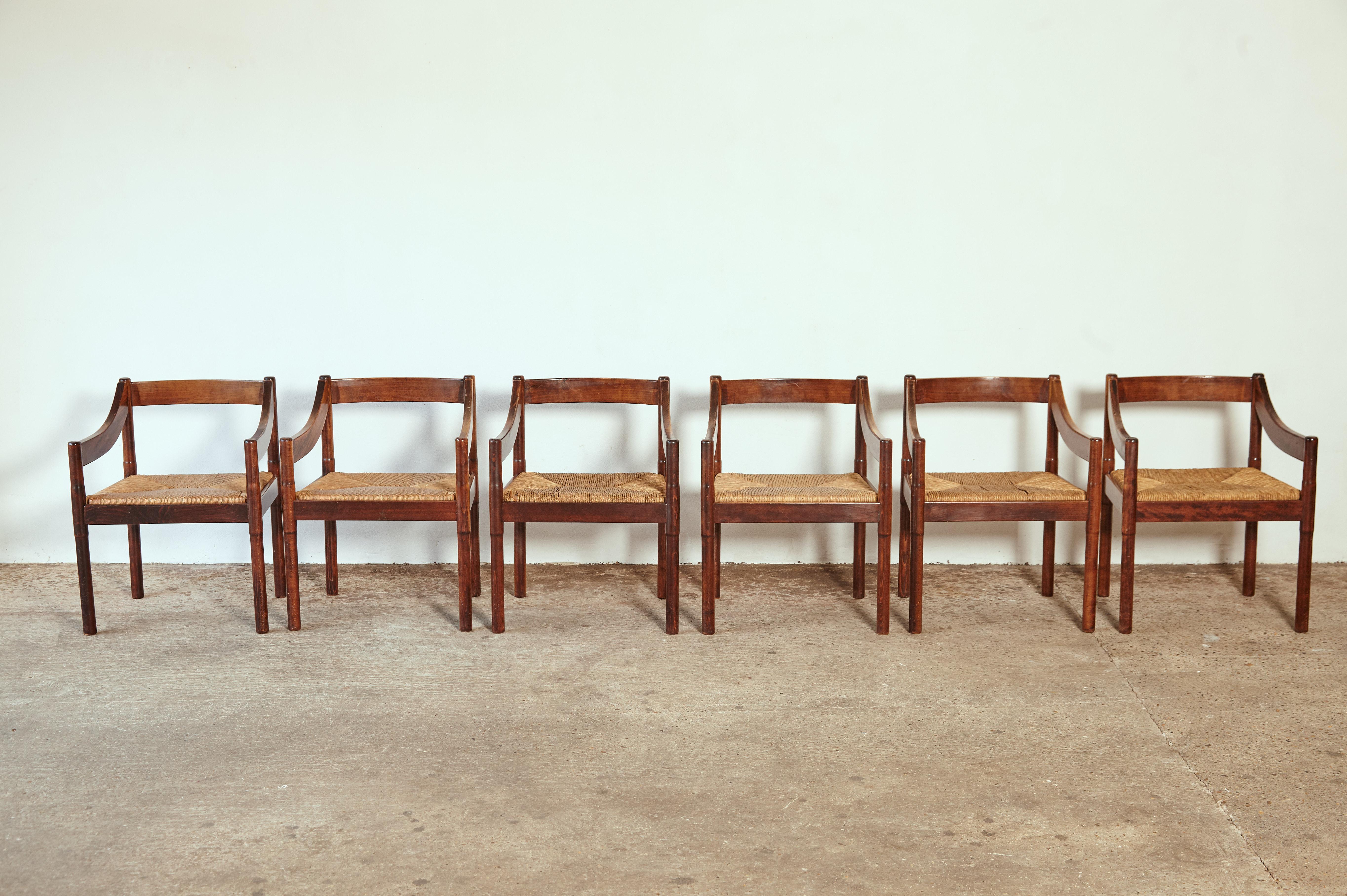 Set of six Vico Magistretti Carimate dining chairs for Cassina, Italy, 1960s. Stained wood and original woven rush seats (minor losses to seats).
        