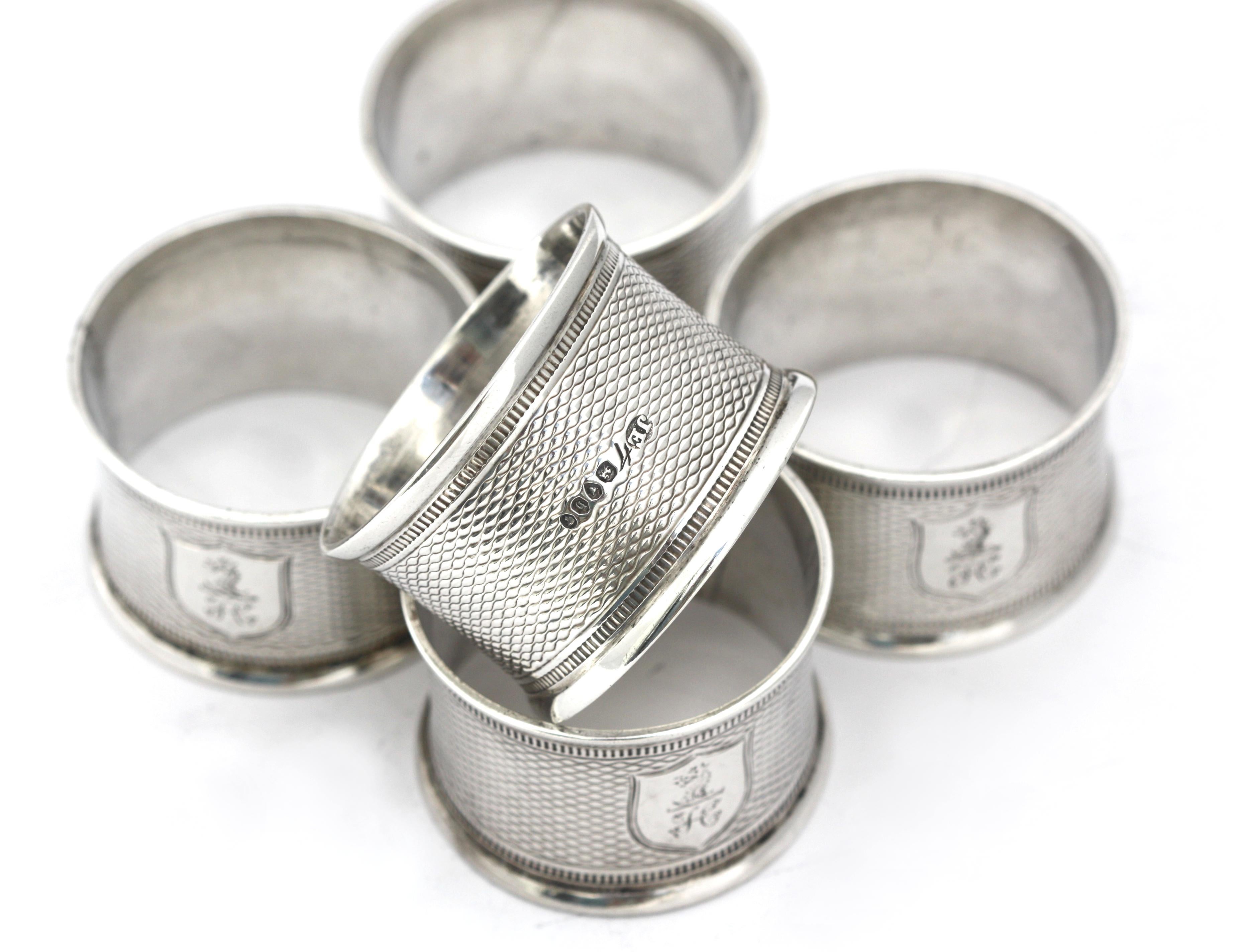 
Six Victorian Silver Napkin Rings
London, 1863, Maker John Evans II. Circular, with a stippled ground etched with an armorial shield centering a dragon head over the initials FC (?). 
Diameter 1.75 in. 3.55 troy oz. (only five photographed)