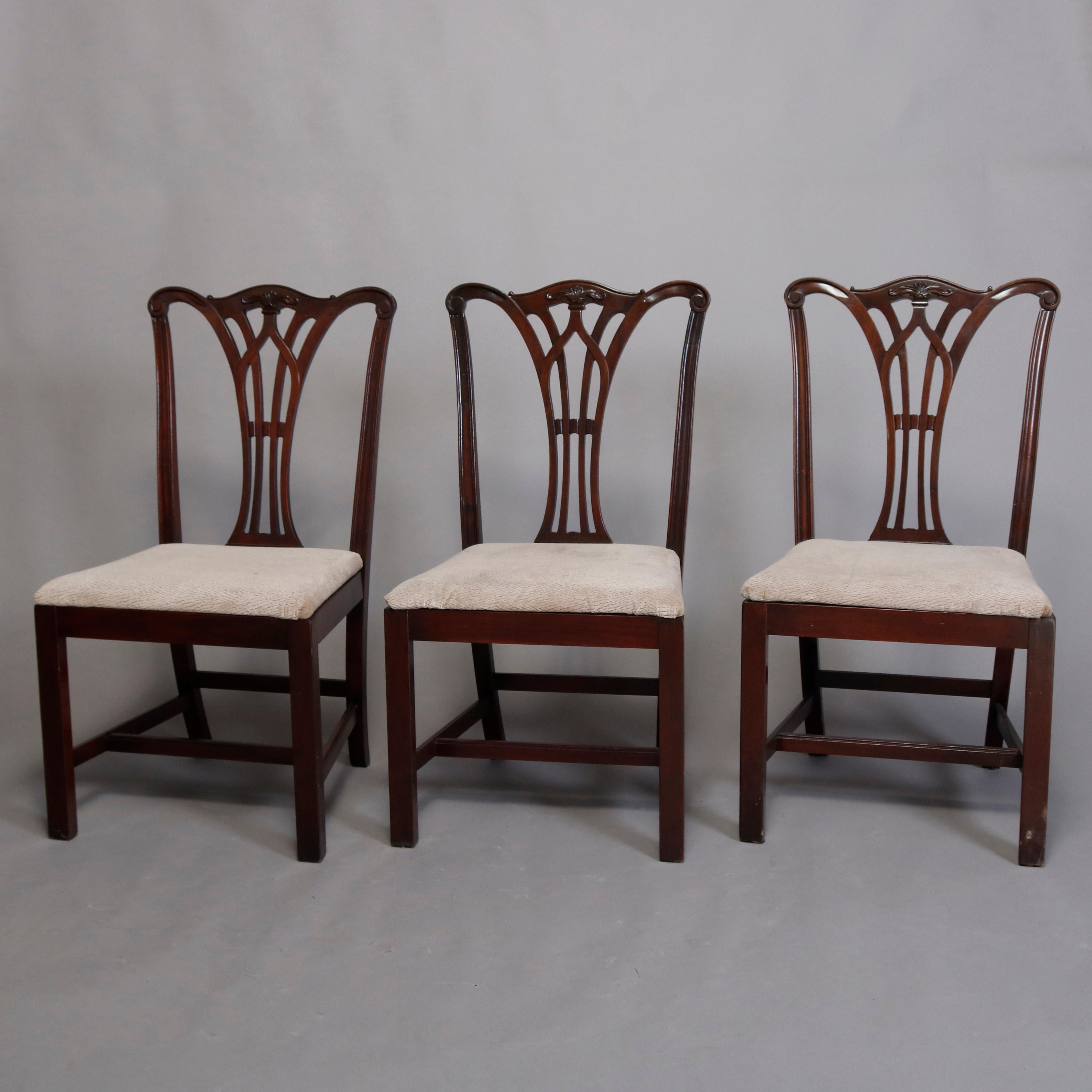 A vintage set of six Chippendale style dining chairs offers carved mahogany frames with ribbon backs having crests with carved foliate reserves and surmounting upholstered seats and raised on square and straight legs, circa 1930

***DELIVERY NOTICE